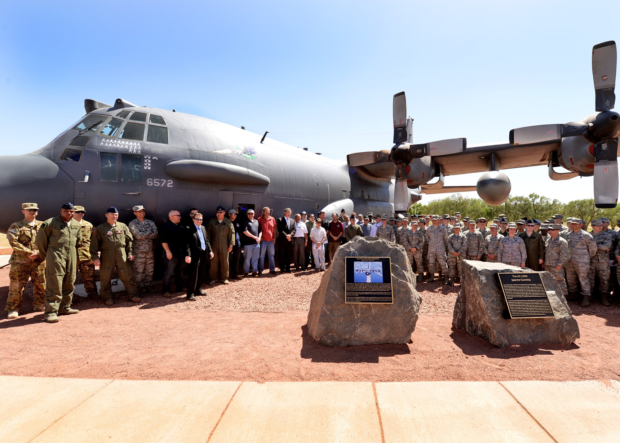 Airmen and retirees young and old pose with “Gravedigger,” a retired AC-130H Spectre gunship memorialized May 6, 2014 at Cannon Air Force Base, N.M. Veterans from conflicts stretching from Vietnam to Operation Enduring Freedom were recognized during the aircraft’s retirement ceremony. (U.S. Air Force Photo/Airman 1st Class Chip Slack)