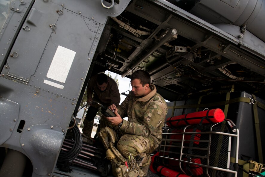 U.S. Air Force Senior Airman Christian Nault, 41st Rescue Squadron special missions aviator out of Moody Air Force Base, Ga., conducts preflight inspections to an HH-60G Pave Hawk May 6, 2014, at Flagstaff Pulliam Airport, Ariz. For two weeks, Nault and his unit will conduct missions in part of Angel Thunder, a joint service, multinational, interagency exercise dedicated to personnel recovery. (U.S. Air Force photo by Staff Sgt. Jamal D. Sutter/Released) 
