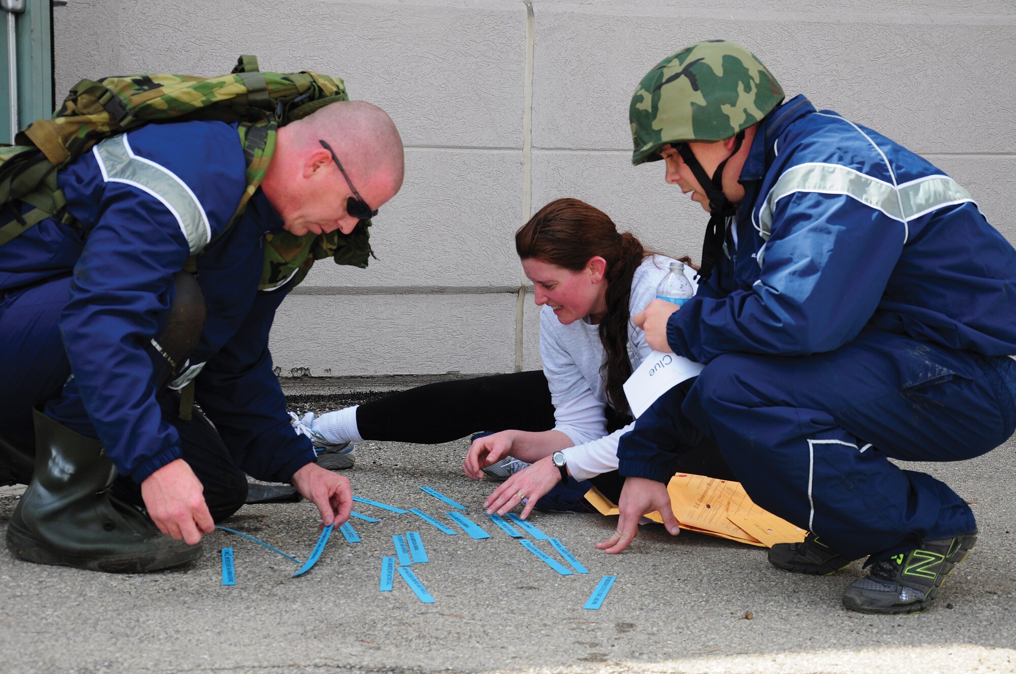 WRIGHT-PATTERSON AIR FORCE BASE, Ohio - Tech. Sgt. Mike Neri, Master Sgt. Alicia Lavender and Senior Airman Jordan Reed, all from the 445th Maintenance Group, unscramble words to create sentences as part of the 445th Maintenance Group Amazing Race teambuilding exercise April 6, 2014. (U.S. Air Force photo/Capt. Elizabeth Caraway)