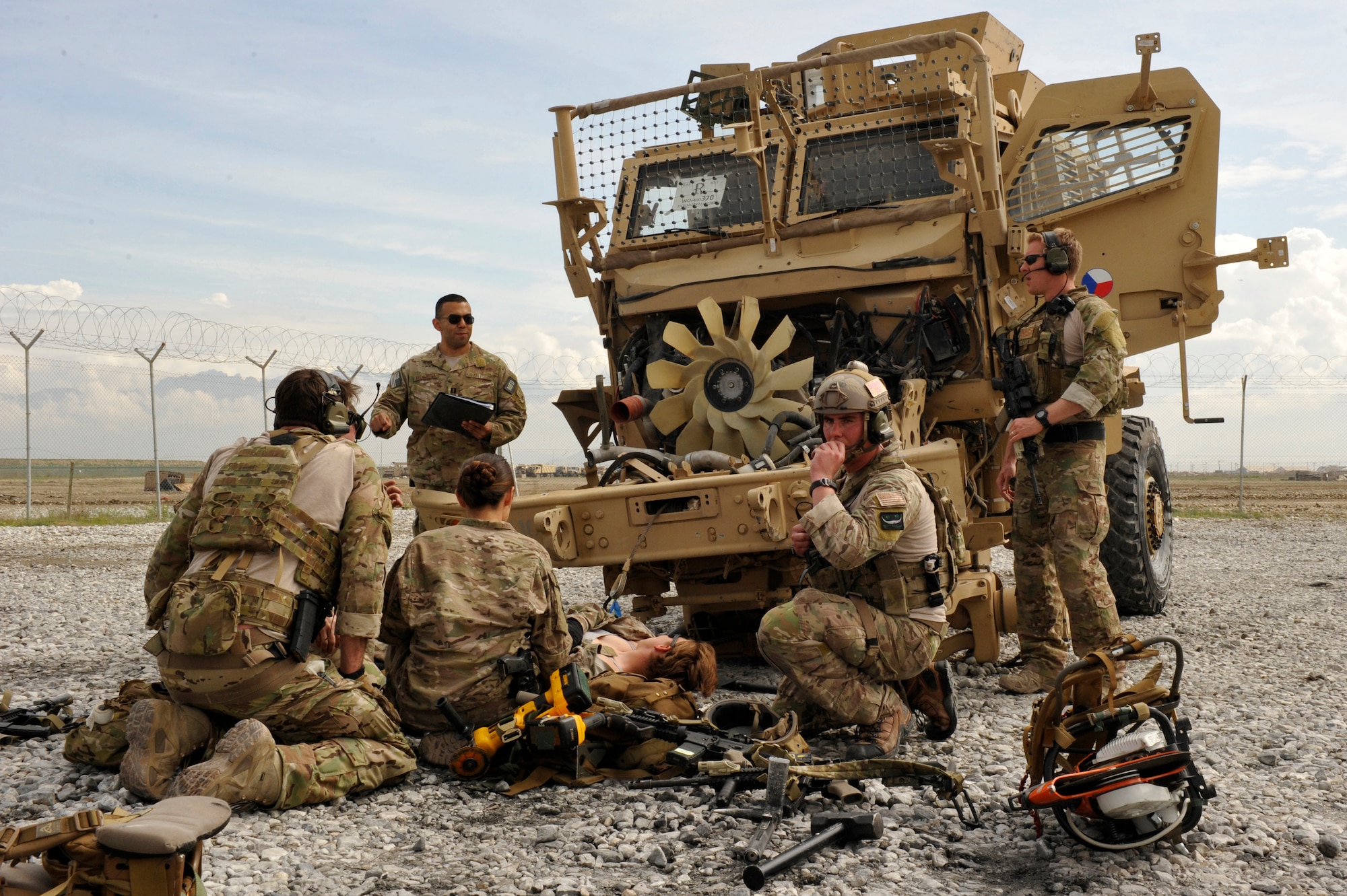 A flight surgeon and pararescuemen from the 83rd ERQS, 455 Air Expeditionary Wing, Bagram Airfield, Afghanistan, treat patients during a training exercise here May 5, 2014. The scenario simulated a vehicle striking an Improvised Explosive Device. During the training, rescue crews flew on HH-60G Pave Hawks to the simulated point of injury, provided security, treated patients, prepared them for travel, and safely departed the area. The rescue team is deployed from Moody Air Force Base, Ga. and Davis-Monthan Air Force Base, Ariz. (U.S. Air Force photo by Maj. Brandon Lingle/Released)