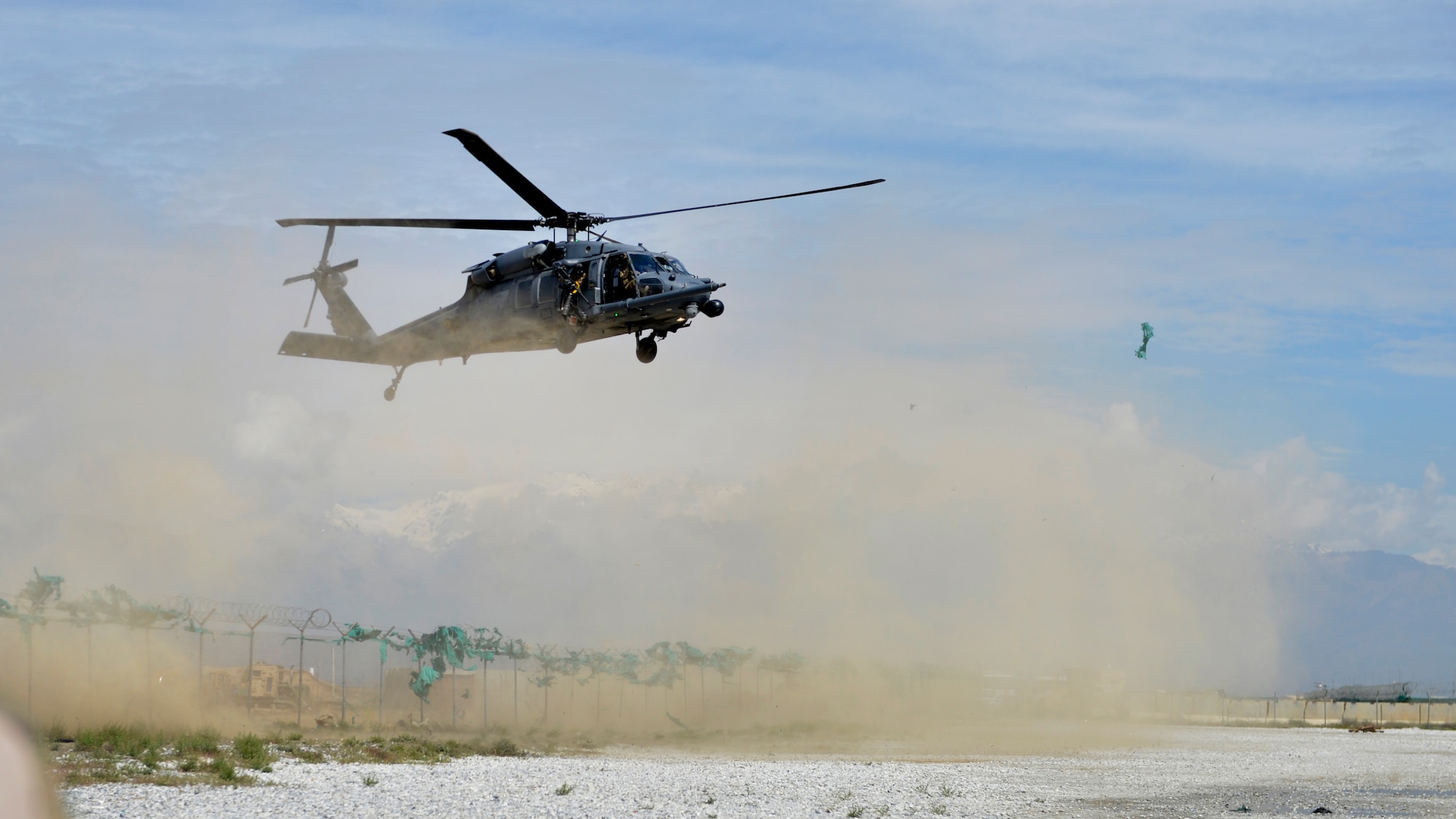A U.S. Air Force HH-60G Pave Hawk approaches a landing zone to pick up simulated casualties during a training exercise at Bagram Airfield, Afghanistan May 5, 2014. The scenario simulated a vehicle striking an Improvised Explosive Device. During the training, rescue crews flew on HH-60G Pave Hawk helicopters to the simulated point of injury, provided security, treated patients, prepared them for travel, and safely departed the area.  The rescue crew is deployed from Moody Air Force Base, Ga.  (U.S. Air Force photo by Staff Sgt. Evelyn Chavez/Released)