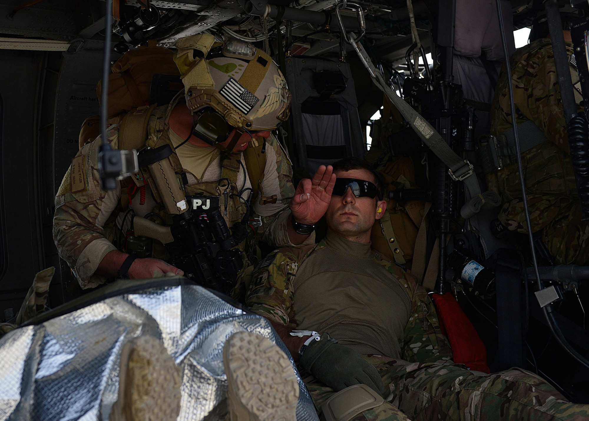 U.S. Air Force Staff Sgt. Justin Tyler, 83rd Expeditionary Rescue Squadron, 455 Air Expeditionary Wing pararescue element leader, treats a simulated casualty in a HH-60G Pave Hawk helicopter at Bagram Airfield, Afghanistan May 5, 2014.  The squadron participated in a training scenario where a vehicle simulated striking an Improvised Explosive Device.  During the training, rescue crews flew on HH-60G Pave Hawks to the simulated point of injury, provided security, treated patients, prepared them for travel, and safely departed the area.  Tyler is a native of Columbia, S.C. and is deployed from Moody Air Force Base, Ga. (U.S. Air Force photo by Staff Sgt. Evelyn Chavez/Released)