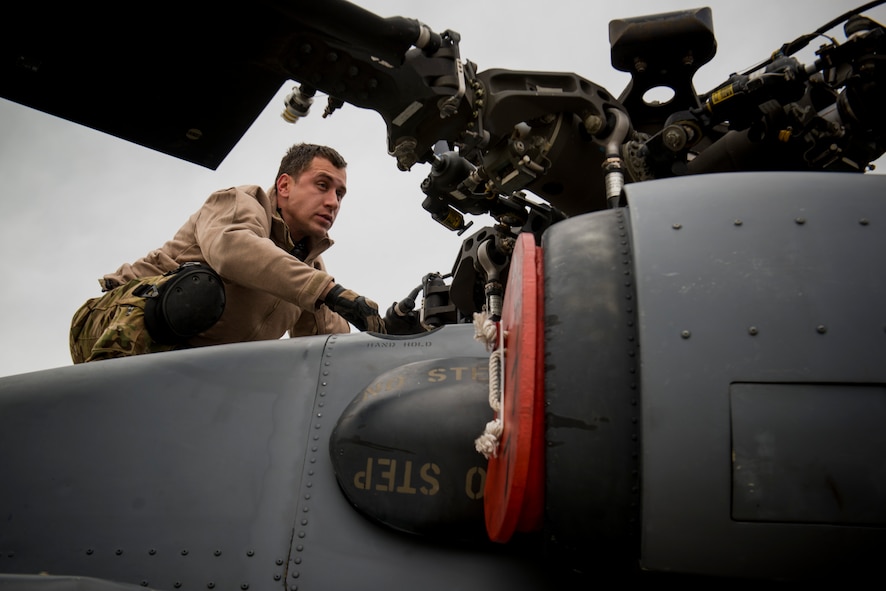 U.S. Air Force Tech. Sgt. Mathias Hauser, 41st Rescue Squadron special missions aviator out of Moody Air Force Base, Ga., inspects the rotor blades of an HH-60G Pave Hawk May 6, 2014, at Flagstaff Pulliam Airport, Ariz. Hauser and his air crew operated the HH-60 during Angel Thunder, an exercise that provides personnel recovery and combat search and rescue training for combat air crews, pararescue, intelligence personnel, battle managers and joint search and rescue center personnel. (U.S. Air Force photo by Staff Sgt. Jamal D. Sutter/Released) 
