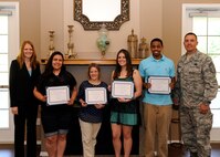 Kamilla Janitell, left, Barksdale Enlisted Spouse Group president, and Chief Master Sgt. Curtis Storms, 2nd Bomb Wing command chief, pose for a photo with scholarship recipients at The Landings on Barksdale Air Force Base, La., May 6, 2014. The BESG selected five scholarship winners based on grade point average and a short essay. (U.S. Air Force photo/Senior Airman Joseph A. Pagán Jr.)