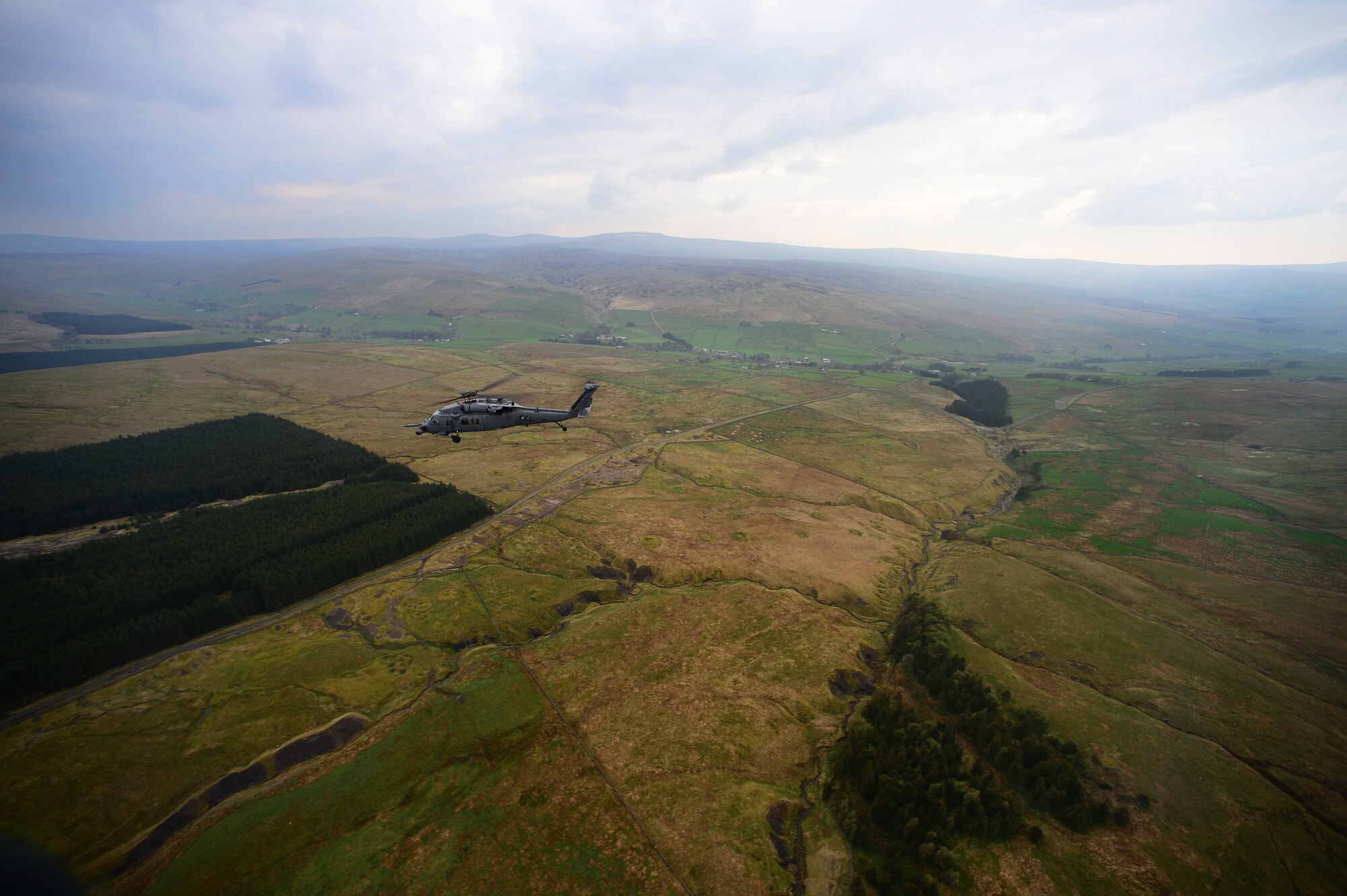 An HH-60G Pave Hawk assigned to the 56th Rescue Squadron returns to Royal Air Force Leeming after electronic warfare training at RAF Spadeadam, England, April 29, 2014. Pilots were trained on evading radar threats in order to gain experience outside of a computer simulation during the week-long training event. (U.S. Air Force photo by Staff Sgt. Emerson Nuñez/Released)