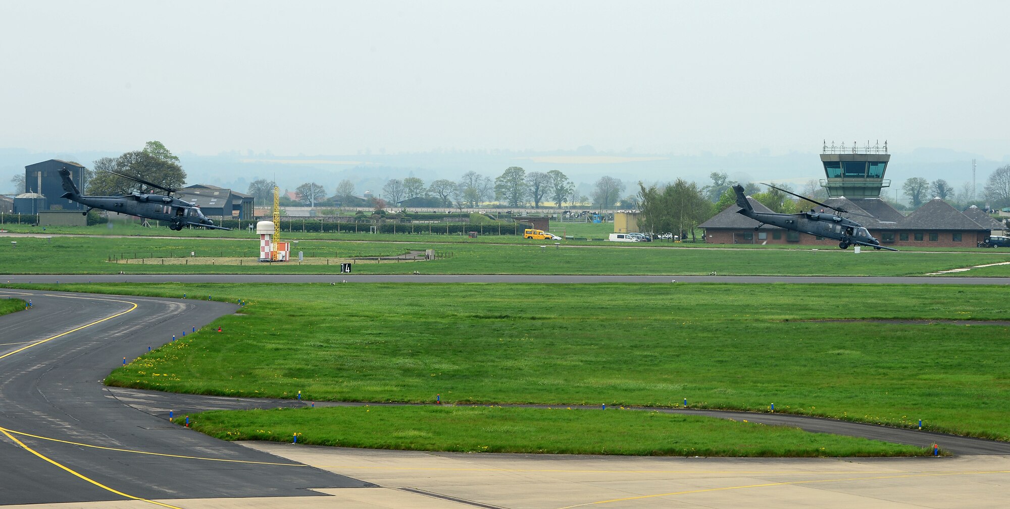 Two HH-60G Pave Hawks assigned to the 56th Rescue Squadron take off from Royal Air Force Leeming, England, April 30, 2014. The 56th RQS spent a week at RAFs Leeming and Spadeadam training to survive, deny and defeat radar threats. (U.S. Air Force photo by Staff Sgt. Emerson Nuñez/Released)