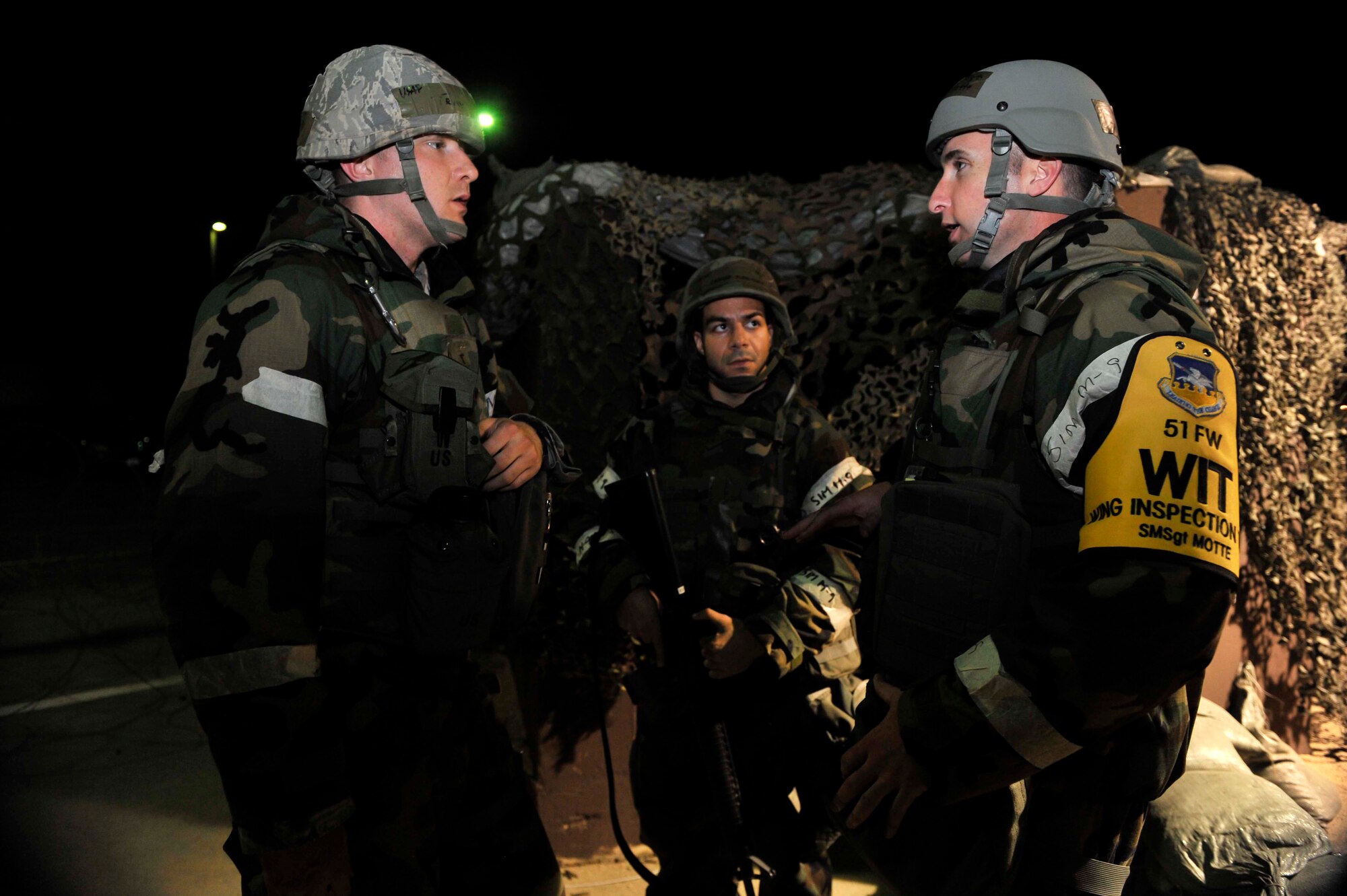 Senior Master Sgt. Jason Motte, 51st Communication Squadron, far right, talks to Airmen about the simulated attack scenario May 7 outside of building 949 on Osan Air Base, Republic of Korea. The scenario was held to help the Airmen improve their response capabilities if they were attacked in a real world scenario. (U.S. Air Force photo by Senior Airman David Owsianka)
