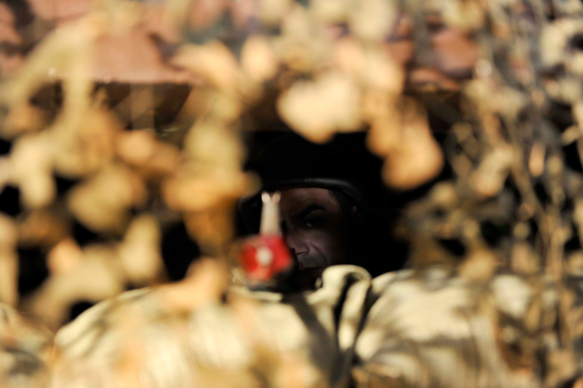 Staff Sgt. Carlos Rodriguez, 51st Communication Squadron, looks out the defense fighting position as opposition forces advanced towards the building 949 May 7 during a simulated attack on Osan Air Base, Republic of Korea. The scenario was held to help the Airmen improve their response capabilities if they were attacked in a real world scenario. (U.S. Air Force photo by Senior Airman David Owsianka)