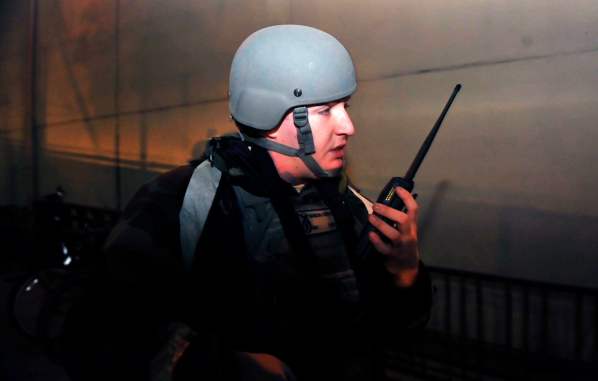 Senior Airman Brandon Conrad, 51st Security Forces Squadron, talks to fellow security forces members inside of building 949 to ensure no opposition forces made it into the building during a simulated attack May 7 on Osan Air Base, Republic of Korea. The scenario was held to help the Airmen improve their response capabilities if they were attacked in a real world scenario. (U.S. Air Force photo by Senior Airman David Owsianka)