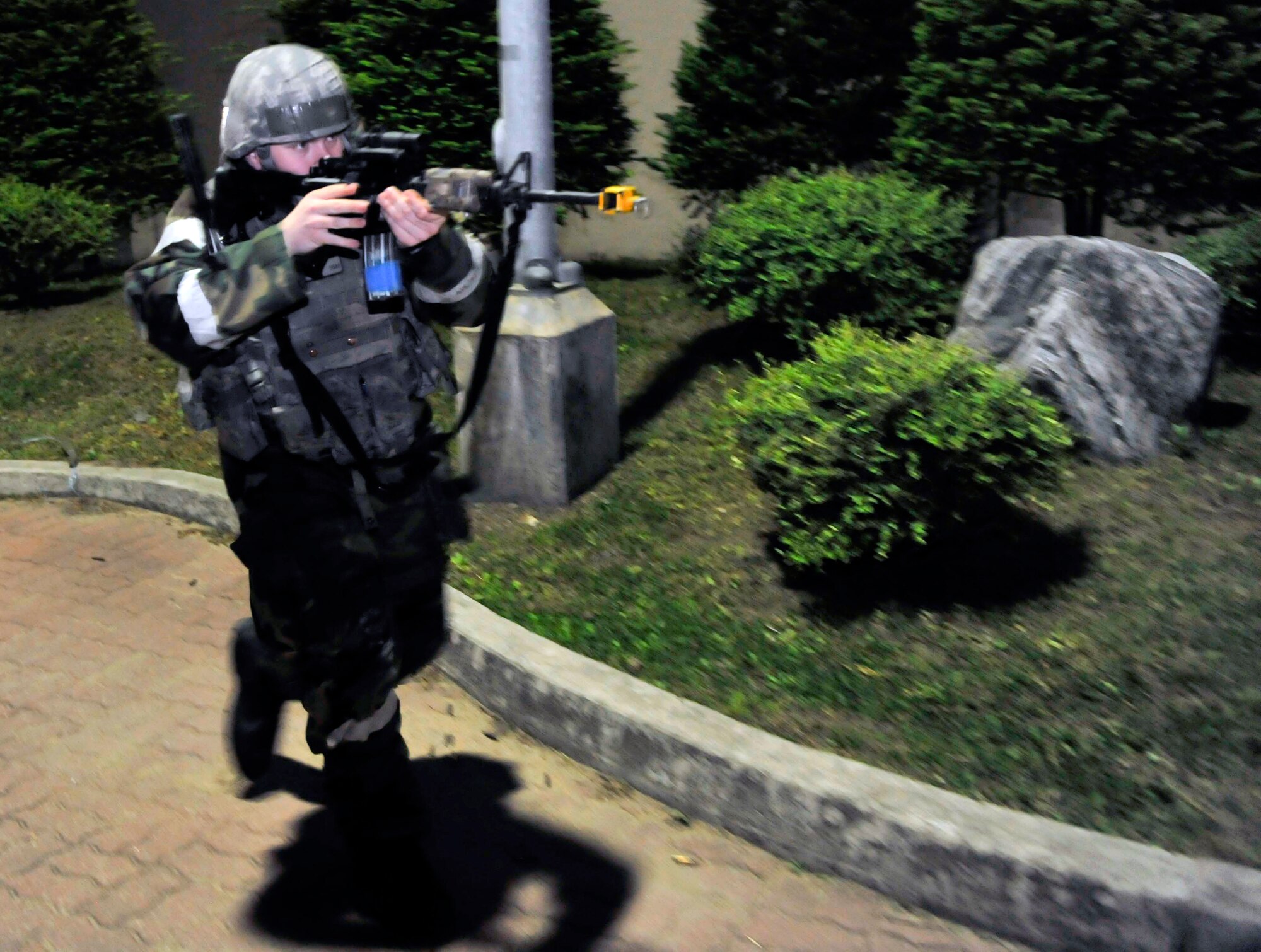Senior Airman Benjamin Weber, 51st Security Forces Squadron, moves around building 949 to clear the perimeter of opposition forces after an attack May 7 during a simulated attack on Osan Air Base, Republic of Korea. The scenario was held to help the Airmen improve their response capabilities if they were attacked in a real world scenario. (U.S. Air Force photo by Senior Airman David Owsianka)