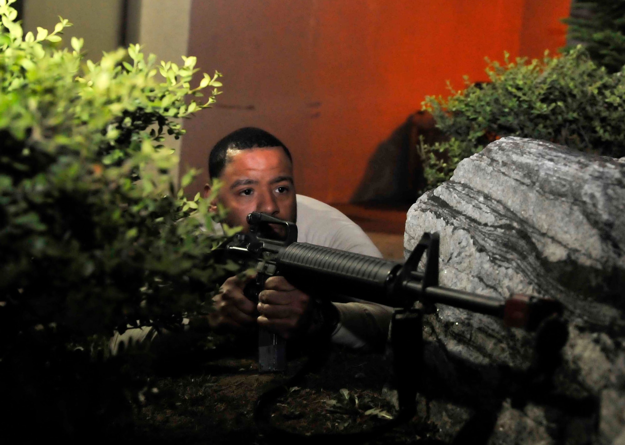 An opposition forces member prepares to takes aim at 51st Security Forces Squadron members inside of a defense fighting position May 7 during a simulated attack outside of building 949 on Osan Air Base, Republic of Korea. The scenario was held to help the Airmen improve their response capabilities if they were attacked in a real world scenario. (U.S. Air Force photo by Senior Airman David Owsianka)