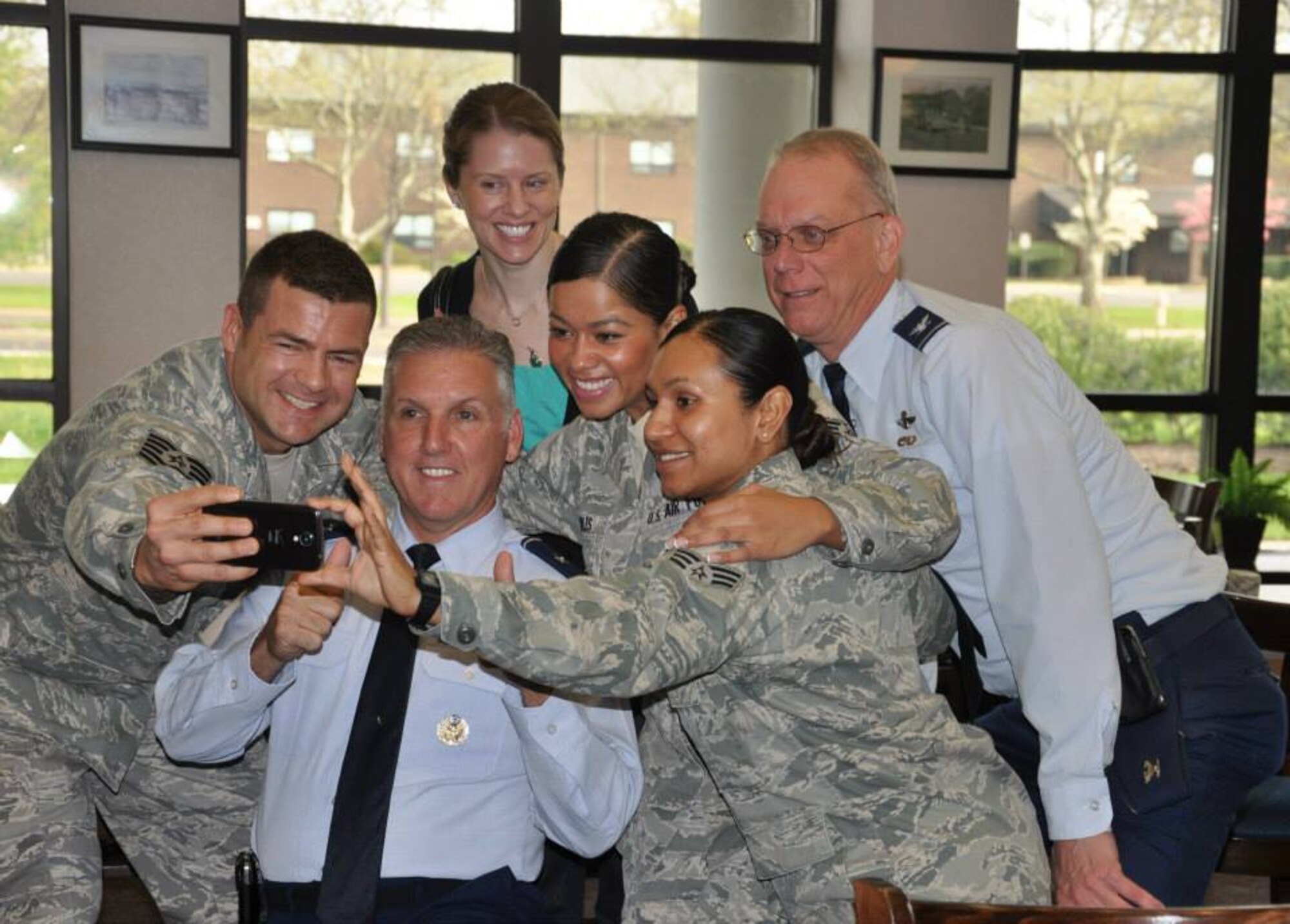 Members of the Freedom Wing take ‘selfie’ photographs with Brig. Gen. John C. Flournoy, Jr., 4th Air Force commander and Col. Michael J. Underkofler, 514th Air Mobility Wing commander, during the Outstanding Airmen Breakfast at Joint Base McGuire-Dix-Lakehurst, N.J., May 3. (U.S. Air Force photo/Capt. Shannon Stoneking)