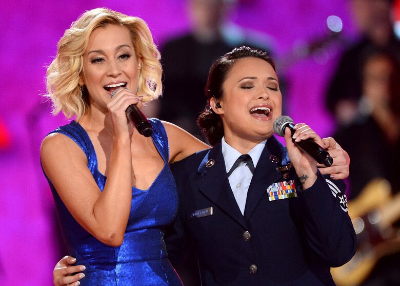 Singer Kellie Pickler, left, and Staff Sgt. Baily Zimmerman, an aircrew aerospace medical craftsman assigned to the 43rd Aeromedical Evacuation Squadron, Pope Army Airfield, Fort Bragg, N.C.,  perform onstage during ACM Presents: An All-Star Salute To The Troops at the MGM Grand Garden Arena on April 7, 2014 in Las Vegas, Nevada.  (Getty Images/ Courtesy of Academy of Country Music)