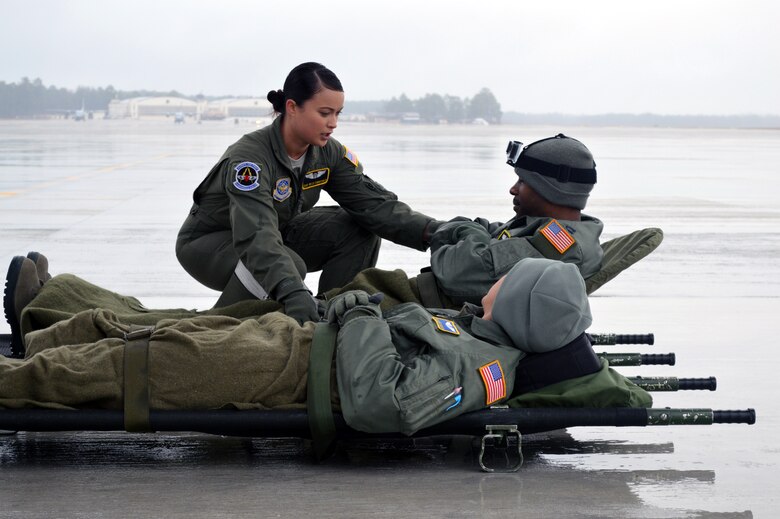 Air Force Staff Sgt. Baily Zimmerman, an aircrew aerospace medical craftsman assigned to the 43rd Aeromedical Evacuation Squadron, prepares simulated patients for transport prior to a local C-130 Hercules aeromedical readiness training mission on March 19, 2014 at Pope Army Airfield, Fort Bragg, N.C. (U.S. Air Force photo/Marvin Krause)
