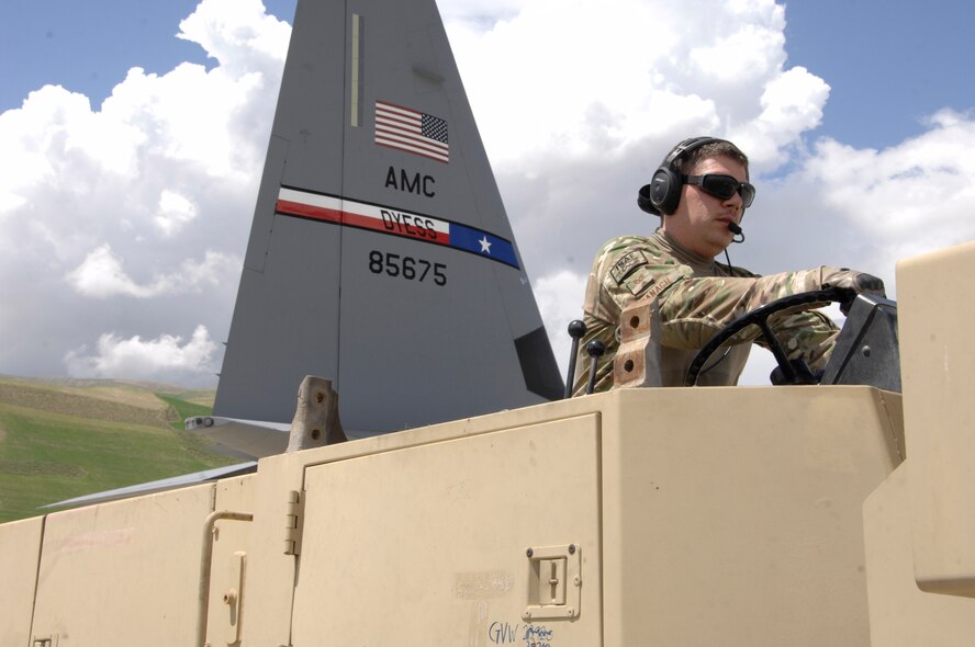 U.S. Air Force Staff Sgt. Nicholas Banach, 774th Expeditionary Airlift Squadron, drives a forklift after using it to unload a pallet from a C-130J Super Hercules May 5, 2014, at Fayzabad Airport, Afghanistan. Banach, a native of Yucca Valley, Calif., was part of a team of Coalition Forces that joined together to assist the Afghan Government with relief efforts after a recent mudslide in Badakhshan province. (U.S. Air Force photo by Master Sgt. Cohen A. Young/ Released)