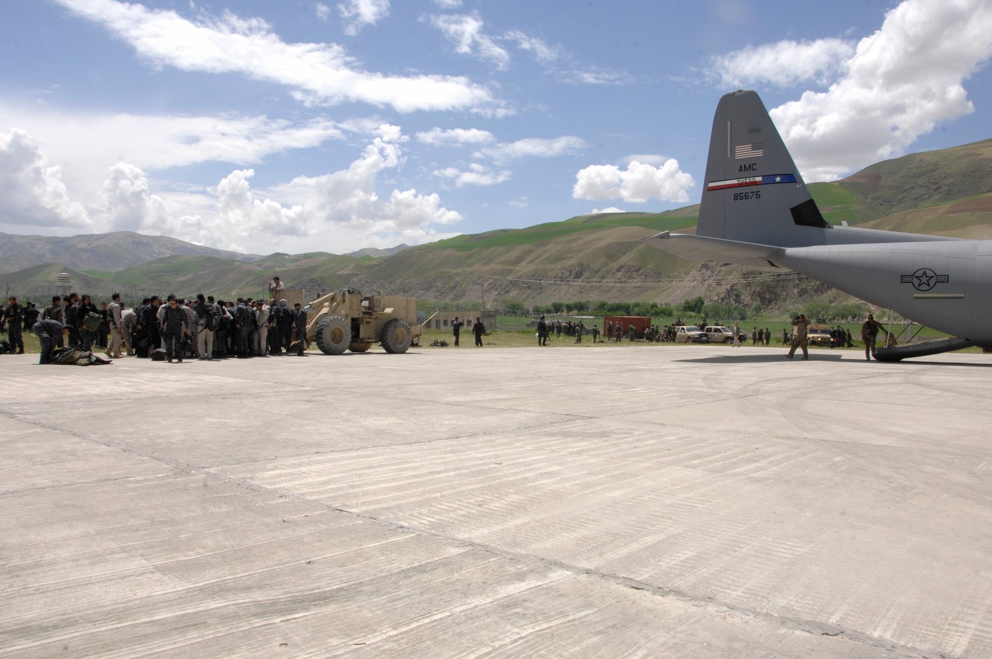 FAYZABAD AIRPORT, Afghanistan – Afghan National Army soldiers and advisors grab their supplies from a pallet after it was unloaded from a C-130 J-30 assigned to the 774th Expeditionary Airlift Squadron, 455th Air Expeditionary Wing, while at Fayzabad Airport May 5, 2014. The crew was part of a Coalition Forces team assisted the Afghan Government with relief efforts after a recent mudslide in Badakhshan province. (U.S. Air Force photo by Master Sgt. Cohen A. Young)