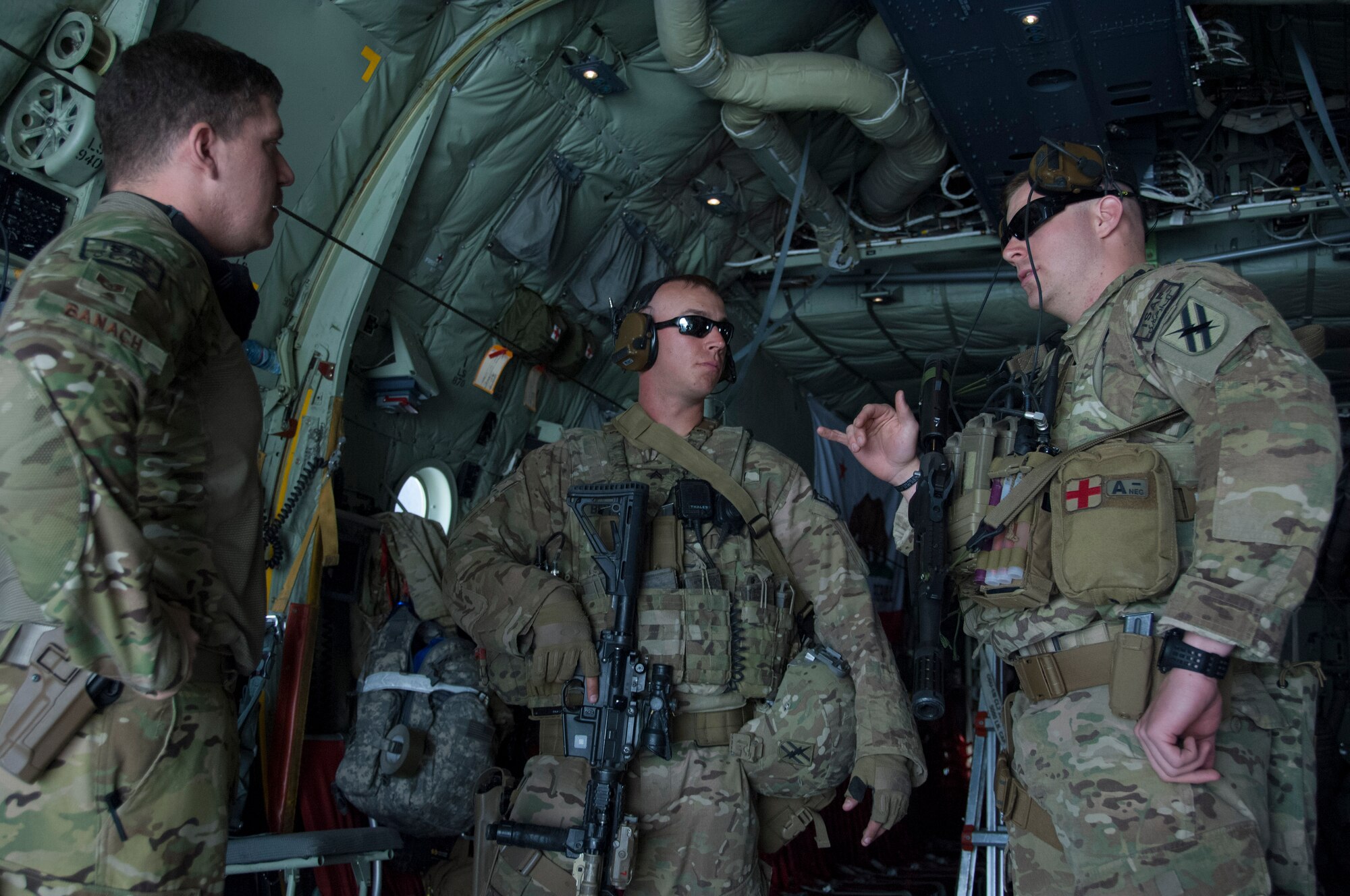 KABUL INTERNATIONAL AIRPORT, Afghanistan - U.S. Air Force Staff Sgt. Nicholas Banach, a loadmaster assigned to the 774th Expeditionary Airlift Squadron, 455th Air Expeditionary Wing speaks with U.S. Army Cpl. Brett Bentley, a native of Senoia, Ga., and U.S. Army Staff Sgt. Robert Mode, a native of Denton, Texas, about security procedures while aboard a C-130 J-30 at Fayzabad Airport May 5, 2014. Bentley and Mode are assigned to the 48th Infantry Brigade Combat Team, Macon Ga., and they joined Banach, a native of Yucca Valley, Calif., when Coalition Forces joined together to assist the Afghan Government with relief efforts after a recent mudslide in Badakhshan province. (U.S. Air Force photo by Master Sgt. Cohen A. Young)