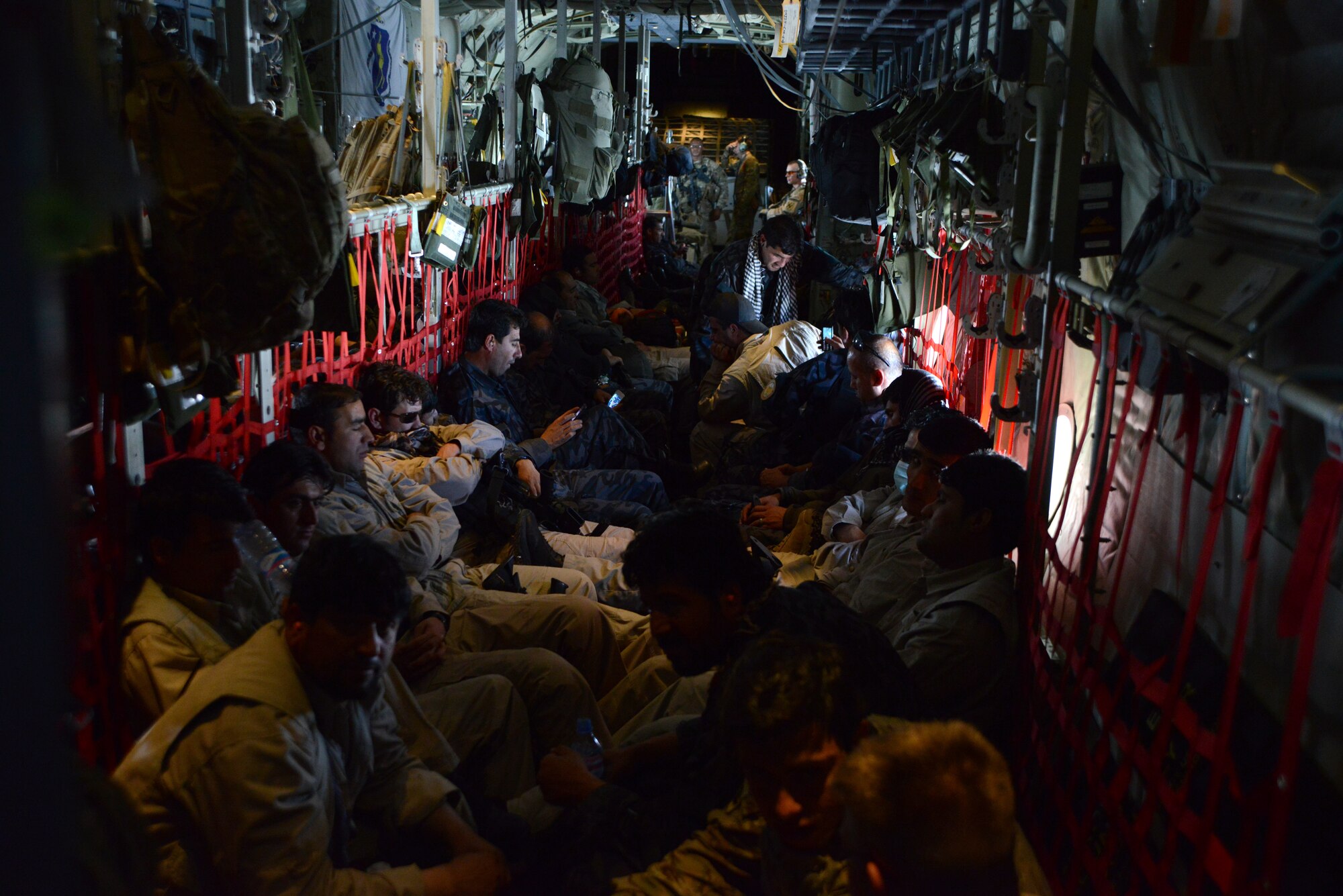 KABUL INTERNATIONAL AIRPORT, Afghanistan – Afghan National Army soldiers and advisors relax as they fly aboard a C-130 J-30 assigned to the 774th Expeditionary Airlift Squadron, 455th Air Expeditionary Wing May 5, 2014. The team was flown to Fayzabad Airport by Coalition Forces so they could make their way to the Badakhshan province, which experienced a mudslide May 2 that is responsible for the loss of lives and damages of a village. (U.S. Air Force photo by Master Sgt. Cohen A. Young)