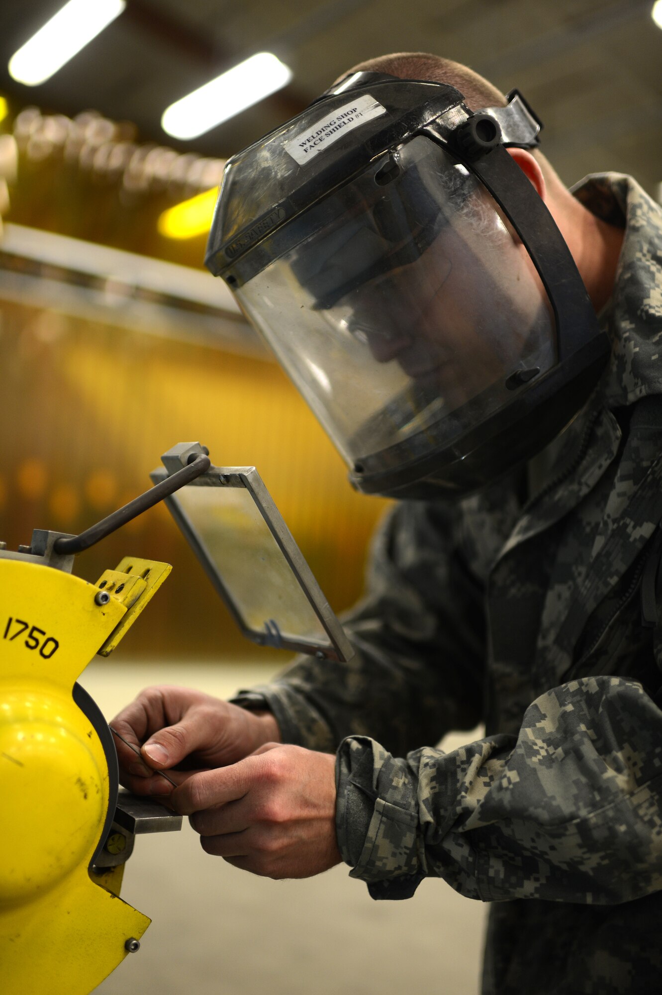 U.S. Air Force Staff Sgt. Steven Doucette, 52nd Equipment Maintenance Squadron metals technology technician from Beaumont, Calif., grinds down a rod of tungsten inside the fabrication flight shop at Spangdahlem Air Base, Germany, May 6, 2014. Doucette grinds the tungsten to a specific shape to channel the power of the welder to a focused point. (U.S. Air Force photo by Senior Airman Gustavo Castillo/Released)
