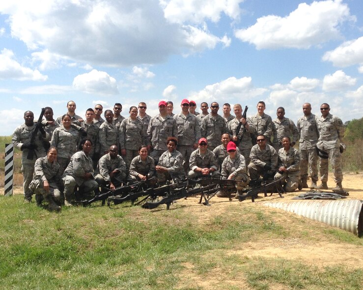 The 459th Security Forces Squadron at Joint Base Andrews, Md., pose for a picture after conducting heavy weapons training at Marine Base Quantico, Virginia, May 3, 2014. The qualifications fulfills annual readiness requirements in order to provide air base ground defense to combatant commanders. (U.S. Air Force photo)