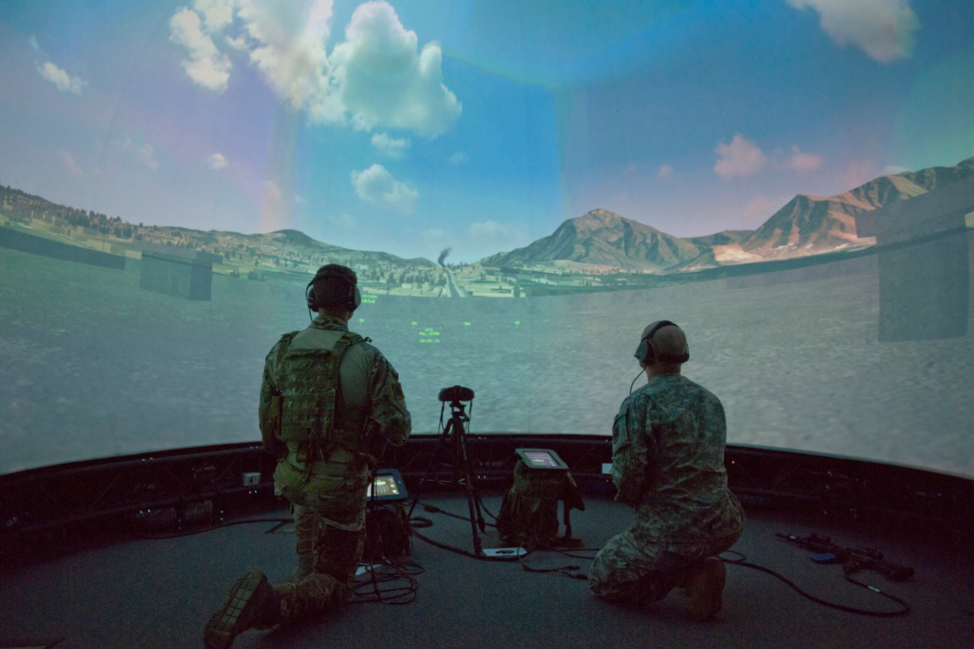 A member of the 146th Air Support Operations Squadron (ASOS), participates in training utilizing the Air National Guard Advanced Joint Terminal Attack Controller Training System (AAJTS) to Brig. Gen. Hopper Smith, assistant adjutant general-Army for the Oklahoma National Guard, during an unveiling of the first operational AAJTS in the nation at Will Rogers Air National Guard Base in Oklahoma City. The AAJTS is a high-fidelity, fully immersive, simulator designed to support Air National Guard (ANG) Joint Terminal Attack Controller (JTAC) and Combat Controller squadron level continuation, qualification and mission rehearsal training. The AAJTS system encompasses high fidelity visual displays, geo-specific visual data bases, equipment emulators, and associated hardware and software. The AAJTS is designed to meet the requirements for unit training at Air Support Operations Squadrons (ASOS) and Special Tactics Squadrons (STS).
PHOTO: Maj. Geoff Legler, Oklahoma National Guard Public 