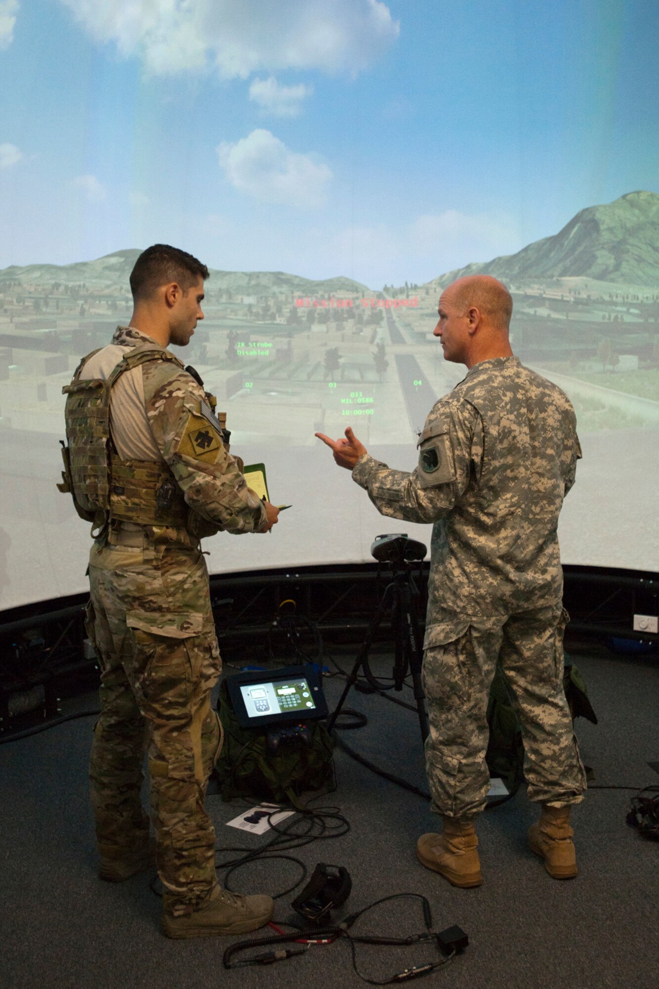 A member of the 146th Air Support Operations Squadron (ASOS), participates in training utilizing the Air National Guard Advanced Joint Terminal Attack Controller Training System (AAJTS) to Brig. Gen. Hopper Smith, assistant adjutant general-Army for the Oklahoma National Guard, during an unveiling of the first operational AAJTS in the nation at Will Rogers Air National Guard Base in Oklahoma City. The AAJTS is a high-fidelity, fully immersive, simulator designed to support Air National Guard (ANG) Joint Terminal Attack Controller (JTAC) and Combat Controller squadron level continuation, qualification and mission rehearsal training. The AAJTS system encompasses high fidelity visual displays, geo-specific visual data bases, equipment emulators, and associated hardware and software. The AAJTS is designed to meet the requirements for unit training at Air Support Operations Squadrons (ASOS) and Special Tactics Squadrons (STS).
PHOTO: Maj. Geoff Legler, Oklahoma National Guard Public 