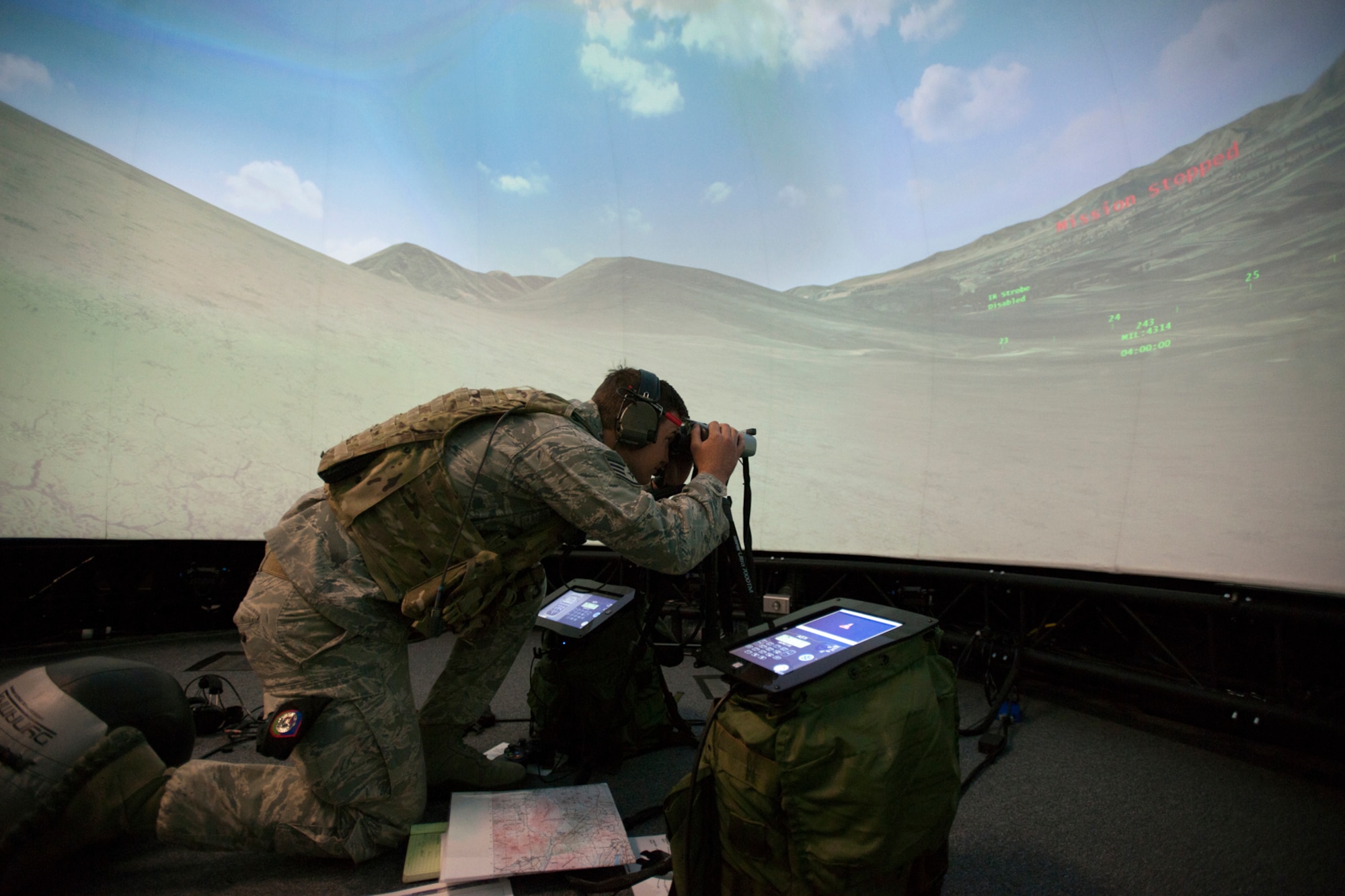 A member of the 146th Air Support Operations Squadron (ASOS), participates in training utilizing the Air National Guard Advanced Joint Terminal Attack Controller Training System (AAJTS) to Brig. Gen. Hopper Smith, assistant adjutant general-Army for the Oklahoma National Guard, during an unveiling of the first operational AAJTS in the nation at Will Rogers Air National Guard Base in Oklahoma City. The AAJTS is a high-fidelity, fully immersive, simulator designed to support Air National Guard (ANG) Joint Terminal Attack Controller (JTAC) and Combat Controller squadron level continuation, qualification and mission rehearsal training. The AAJTS system encompasses high fidelity visual displays, geo-specific visual data bases, equipment emulators, and associated hardware and software. The AAJTS is designed to meet the requirements for unit training at Air Support Operations Squadrons (ASOS) and Special Tactics Squadrons (STS).
PHOTO: Maj. Geoff Legler, Oklahoma National Guard Public 
