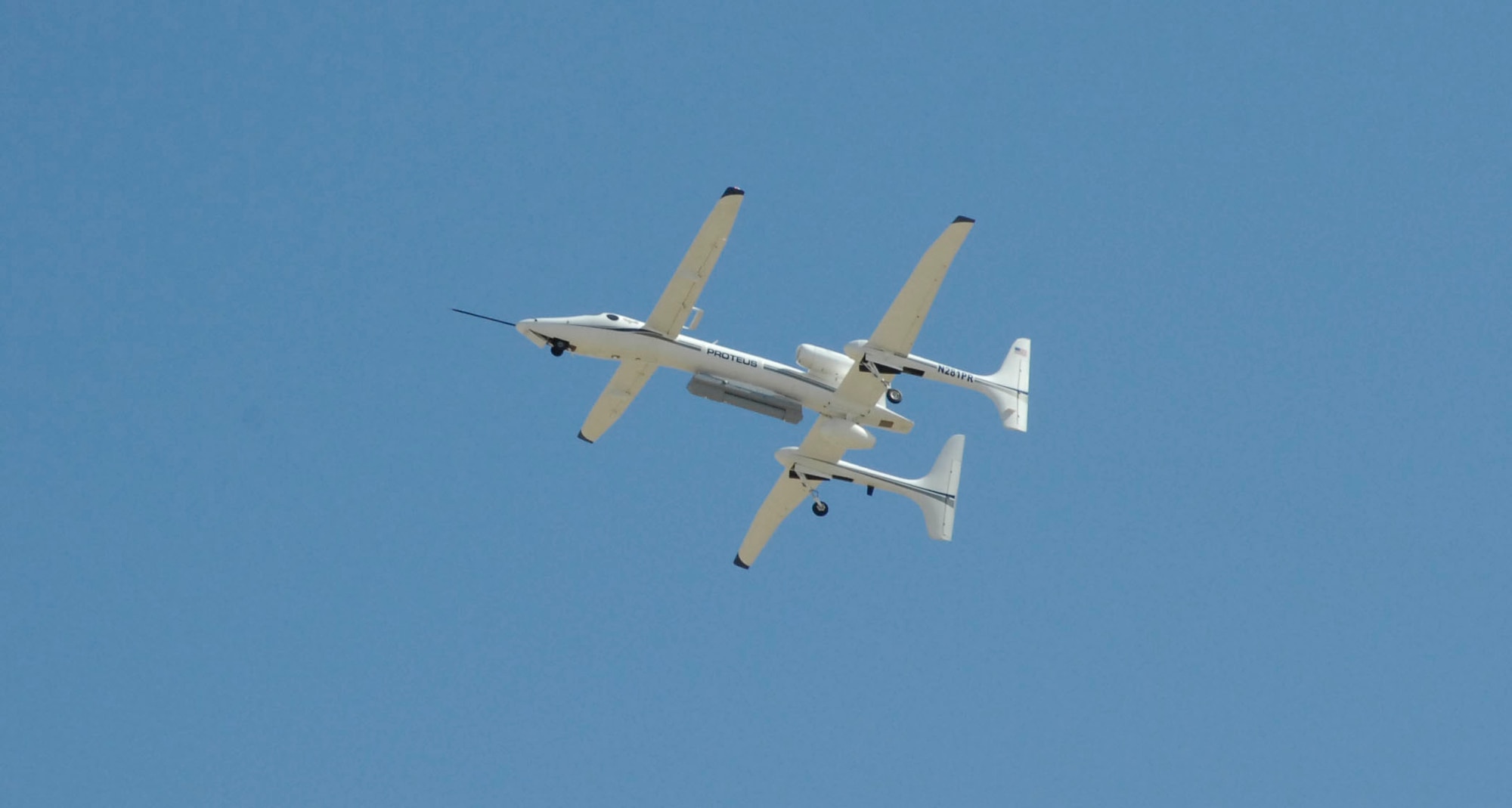 The Dismount Detection Radar pod, mounted on the Proteus aircraft, undergoes its first developmental test flight in the airspace above Mojave, Calif., April 22, 2014. The DDR will serve as an open systems architecture radar model for other systems. Flight testing will continue this summer to verify the mode and gauge the performance characteristics of the radar. (U.S. Air Force photo by 1st Lt. Matthew Cook)