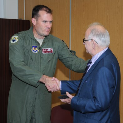 U.S. Air Force Col. Kenneth T. Bibb, Jr., left, 100th Air Refueling Wing commander, presents Zigi Shipper, a holocaust survivor, with a “Square D” memento following a question and answer session April 30, 2014, in the base chapel on RAF Mildenhall, England. Shipper was born to Orthodox Jewish parents in Poland in 1930 and spent many years in ghettos and concentration camps during World War II. While living in the ghetto, Shipper worked in a metal factory. When the ghetto was liquidated in 1944, everyone from the metal factory was put onto cattle trucks and sent to Auschwitz-Birkenau. (U.S. Air Force photo by Gina Randall/Released)