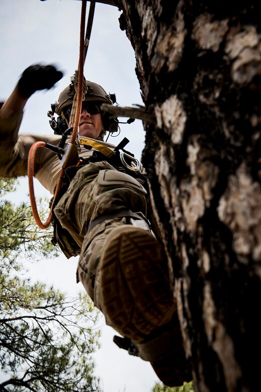 A U.S. Air Force pararescueman from the 58th Rescue Squadron (RQS) out of Nellis Air Force Base, Nev., performs tree let-down procedures May 5, 2014, at Camp Navajo, Ariz., in part of the Angel Thunder exercise. Though stationed at Nellis, the 58th RQS is a geographically-separated unit of the 23d Wing at Moody Air Force Base, Ga. (U.S. Air Force photo by Staff. Sgt. Jamal D. Sutter/Released) 