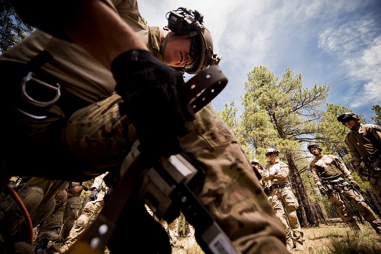 A U.S. Air Force pararescueman from the 58th Rescue Squadron out of Nellis Air Force Base, Nev., equips himself with tree let-down gear May 5, 2014, at Camp Navajo, Ariz., in part of Angel Thunder. During the exercise, Airmen in the unit will participate in various scenarios to satisfy part-task training requirements and become more proficient at their job. (U.S. Air Force photo by Staff. Sgt. Jamal D. Sutter/Released)  