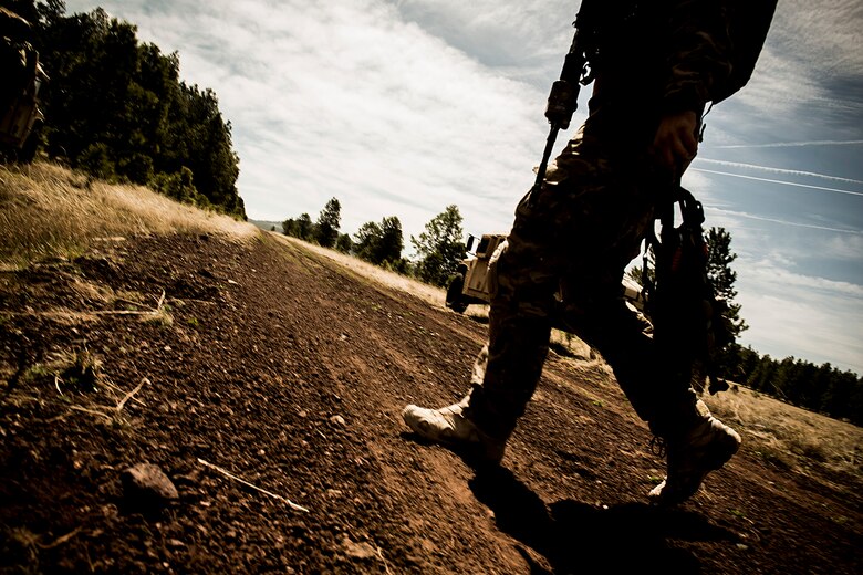 A U.S. Air Force pararescueman from the 58th Rescue Squadron out of Nellis Air Force Base, Nev., makes his way to a training site in part of Angel Thunder May 5, 2014, at Camp Navajo, Ariz. Angel Thunder is an exercise that provides personnel recovery and combat search and rescue training for combat air crews, pararescue, intelligence personnel, battle managers and joint search and rescue center personnel. (U.S. Air Force photo by Staff. Sgt. Jamal D. Sutter/Released) 