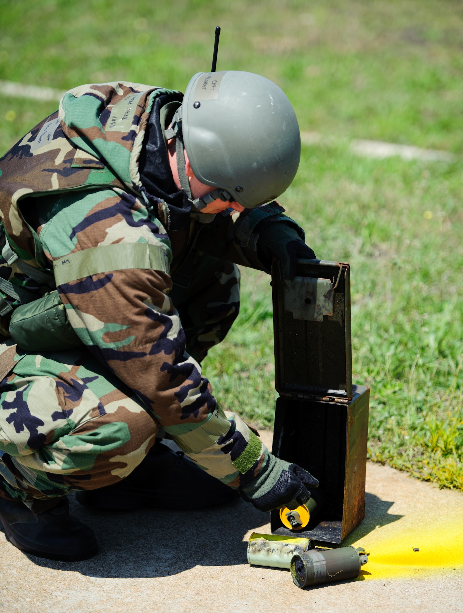 Capt. Beau Provost, 8th Fighter Wing assistant inspector general, discards used smoke grenades after a simulated hit at Kunsan Air Base, Republic of Korea, May 7, 2014. The Wolf Pack continued to prove its combat readiness as they entered the third day of the peninsula-wide operational readiness exercise. (U.S. Air Force photo by Senior Airman Armando A. Schwier-Morales/Released)