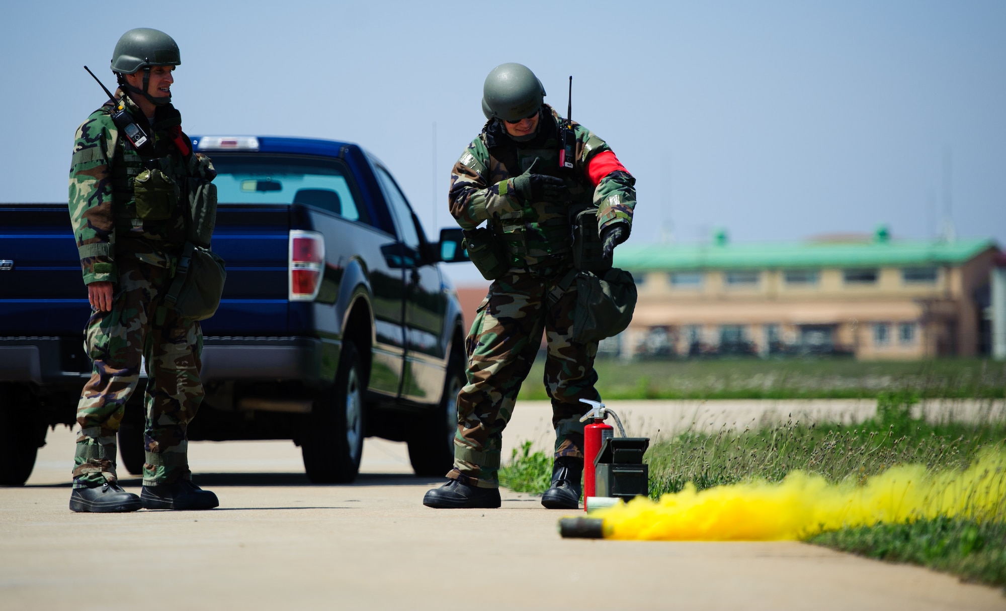 Lt. Col. Michael Matesick, 8th Fighter Wing inspector general, and Capt. Beau Provost, 8th Fighter Wing assistant inspector general, await the reaction of civil engineer members after a simulated high explosive hit at Kunsan Air Base, Republic of Korea, May 7, 2014.  The Wolf Pack continued to prove its combat readiness as they entered the third day of the peninsula-wide operational readiness exercise. (U.S. Air Force photo by Senior Airman Armando A. Schwier-Morales/Released)