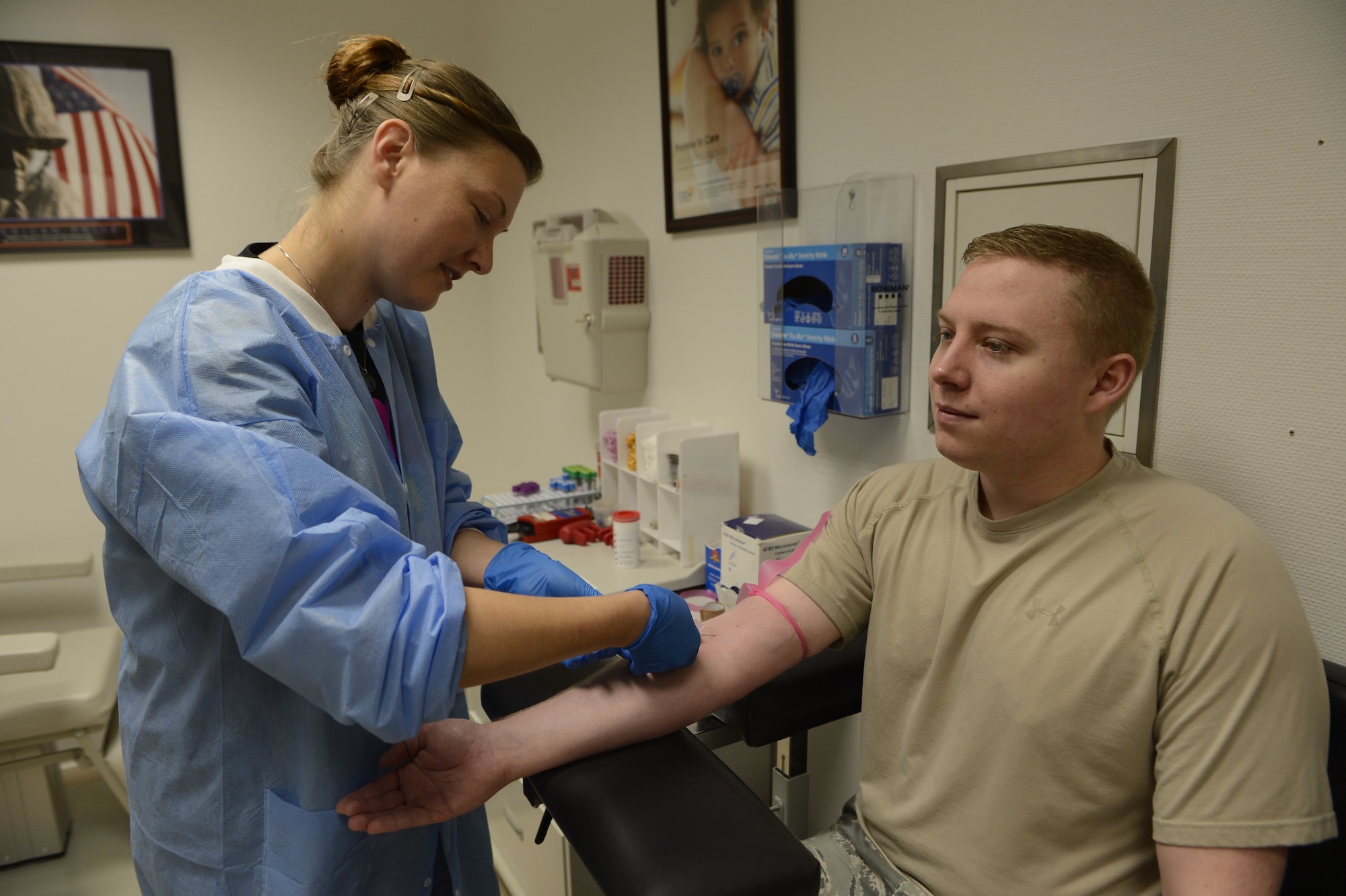 Toni Hartly, 52nd Medical Support Squadron intern from Tupelo, Miss., draws blood from U.S. Air Force Staff Sgt. Lukas Bedsaul, 606th Air Control Squadron unit deployment manager from Gautier, Miss., at Spangdahlem Air Base, Germany, May 1, 2014.  Laboratory technicians collect blood, urine, stool and saliva samples to analyze and diagnose patients’ health. (U.S. Air Force photo by Staff Sgt. Christopher Ruano/Released)