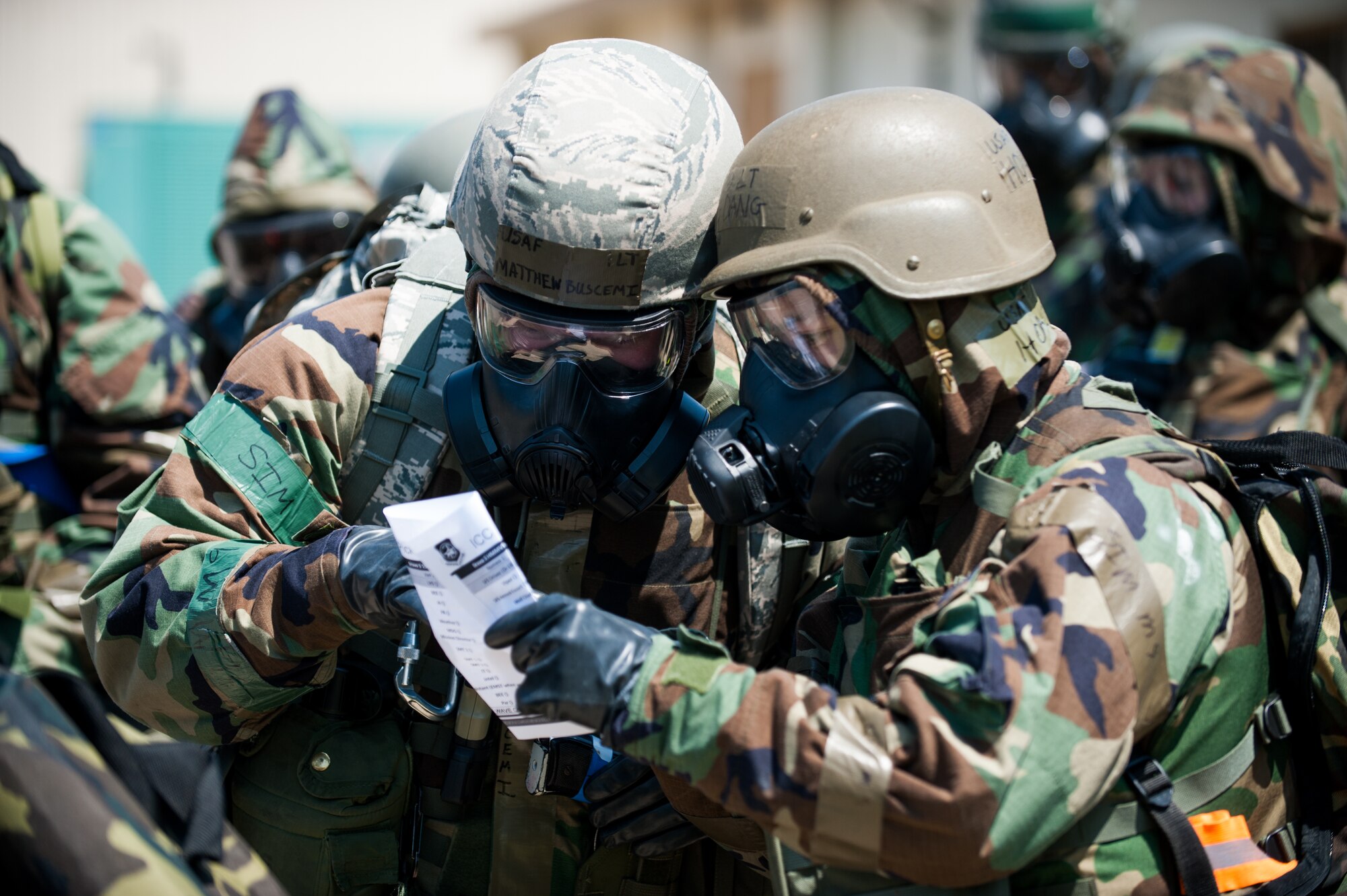 First Lt. Matthew Buscemi, 8th Civil Engineer Squadron readiness and emergency management flight commander, and 2nd Lt. Hoang Dang, 8th Communications Squadron plans and resources flight commander, take accountability after an evacuation during exercise Beverly Bulldog 14-2 at Kunsan Air Base, Republic of Korea, May 7, 2014. The Wolf Pack continued to prove its combat readiness as they entered the third day of the peninsula-wide operational readiness exercise. (U.S. Air Force photo by Staff Sgt. Clayton Lenhardt/Released)