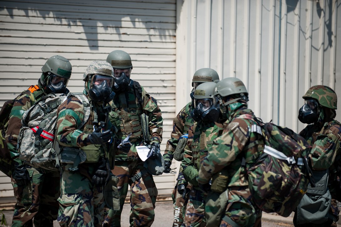 Members of the 8th Fighter Wing emergency operations center await transportation to an alternate location during exercise Beverly Bulldog 14-2 at Kunsan Air Base, Republic of Korea, May 7, 2014. The Wolf Pack continued to prove its combat readiness as they entered the third day of the peninsula-wide operational readiness exercise. (U.S. Air Force photo by Staff Sgt. Clayton Lenhardt/Released)