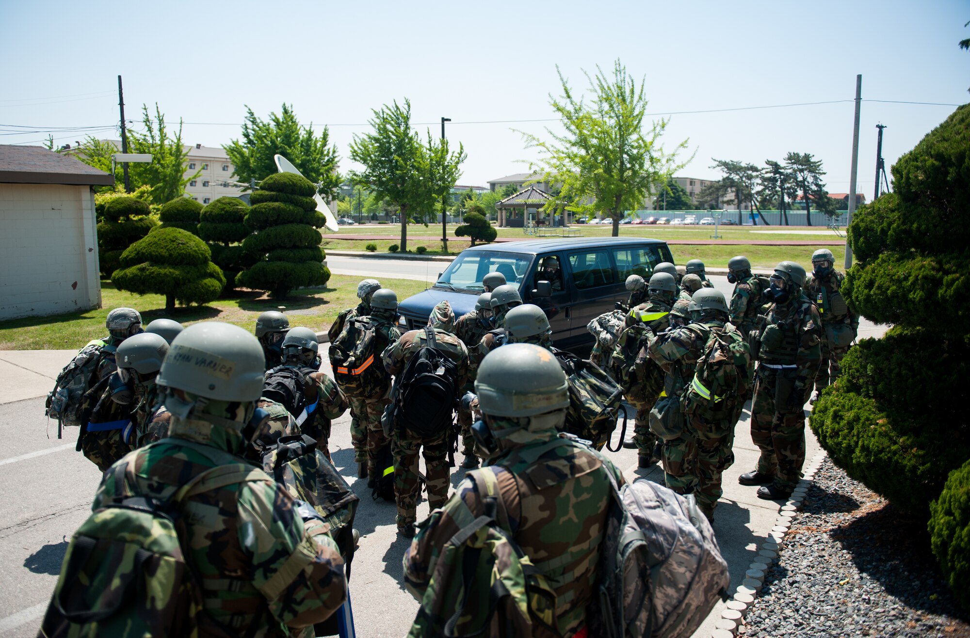 Members of the 8th Fighter Wing emergency operations center await transportation to an alternate location during exercise Beverly Bulldog 14-2 at Kunsan Air Base, Republic of Korea, May 7, 2014. The Wolf Pack continued to prove its combat readiness as they entered the third day of the peninsula-wide operational readiness exercise. (U.S. Air Force photo by Staff Sgt. Clayton Lenhardt/Released)