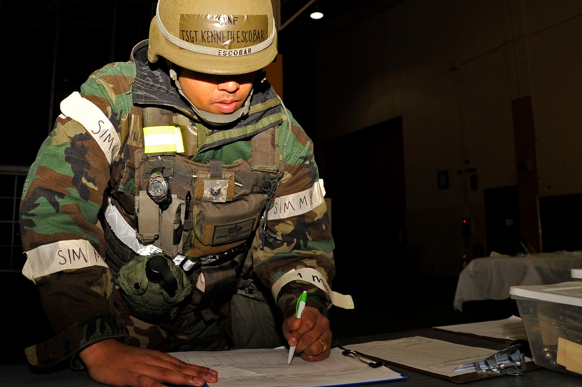 U.S. Air Force Tech. Sgt. Kenneth Escobar, 35th Force Support Squadron fitness specialist, prepares paperwork for simulated casualties at the mortuary affairs building during Phase II of an Operational Readiness Exercise at Misawa Air Base, Japan, May 7, 2014. Fallen Airmen during ORE scenarios are sent to mortuary affairs to be processed for records and examinations prior to being transported. (U.S. Air Force photo/Airman 1st Class Patrick Ciccarone)