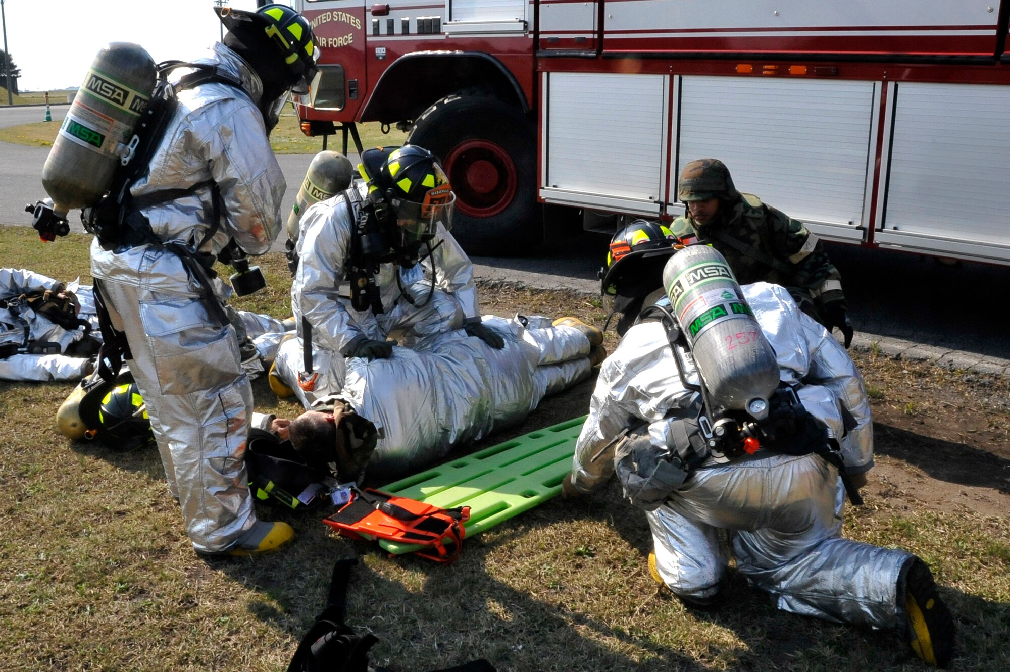 Firefighters from the 35th Civil Engineer Squadron respond and transport simulated casualties to mortuary affairs during an Operation Readiness Exercise scenario at Misawa Air Base, Japan, May 7, 2014. Several firefighters battled flames and provided first aid after a simulated fuel tanker explosion inject during Phase II of the ORE. (U.S. Air Force photo/Airman 1st Class Patrick Ciccarone)