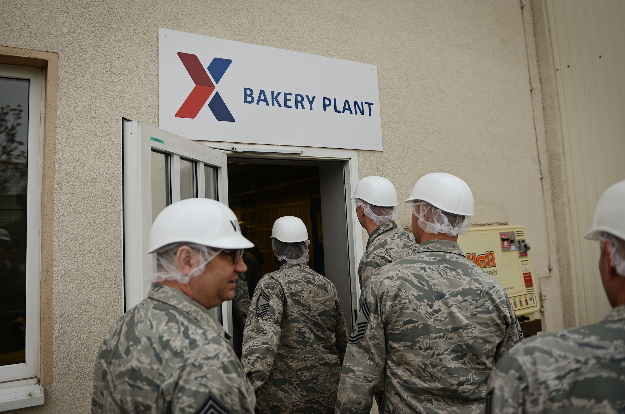 Chiefs from Ramstein Air Base Germany enter the Army and Air Forces Exchange Service bakery plant in Gruenstadt, Germany during a familiarization tour April 30, 2014. The Gruenstadt facility is the central production location for more than 250 line items, as well as cold storage for 200 line items and even produces five million gallons of Culligan bottled water each year. The plant distributes to more than 100 locations in 25 countries and has been in business since 1953. (U.S. Air Force photo/ Staff Sgt. Ryan Crane)