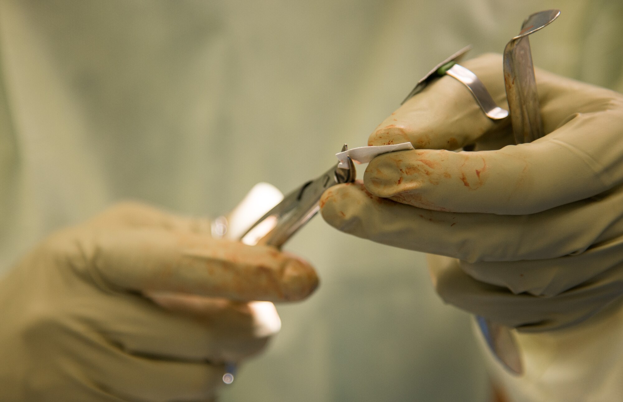 Maj. Curtis Hayes, 86th Dental Squadron chief oral and maxillofacial surgeon, cuts a membrane during a dental implant surgery at Ramstein Air Base, Germany, April 29, 2014. Standing out from thousands of dental Airmen around the world Hayes was named Air Force Dentist of the Year for his outstanding accomplishments. (U.S. Air force photo/Senior Airman Jonathan Stefanko)