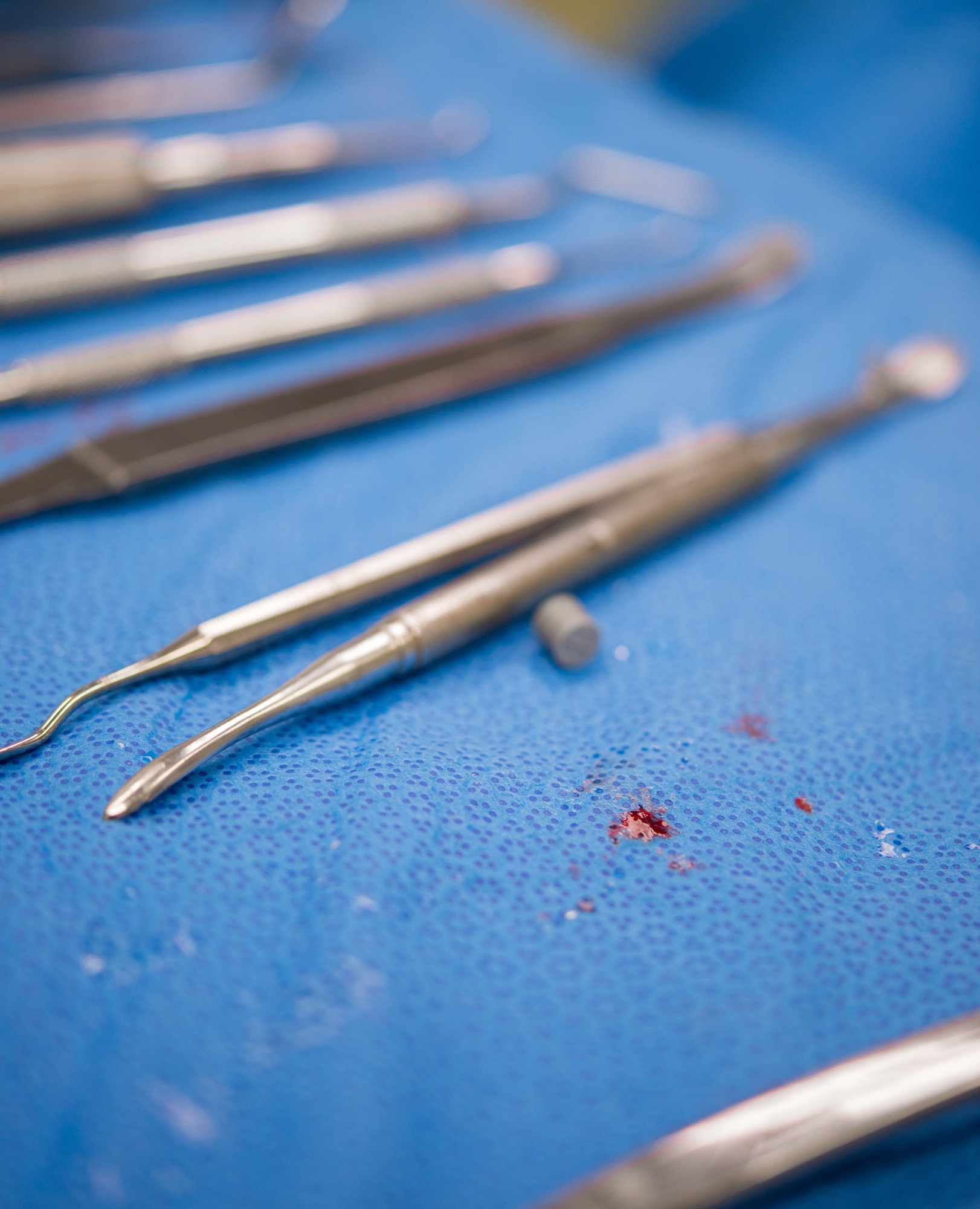 A speck of blood from the patient drips on a table during a dental implant surgery at Ramstein Air Base, Germany, April 29, 2014. Performing dental implants is a routine operation for Airmen like Maj. Curtis Hayes, 86th Dental Squadron chief oral and maxillofacial surgeon, who was named Air Force Dentist of the Year for his outstanding accomplishments. (U.S. Air force photo/Senior Airman Jonathan Stefanko)