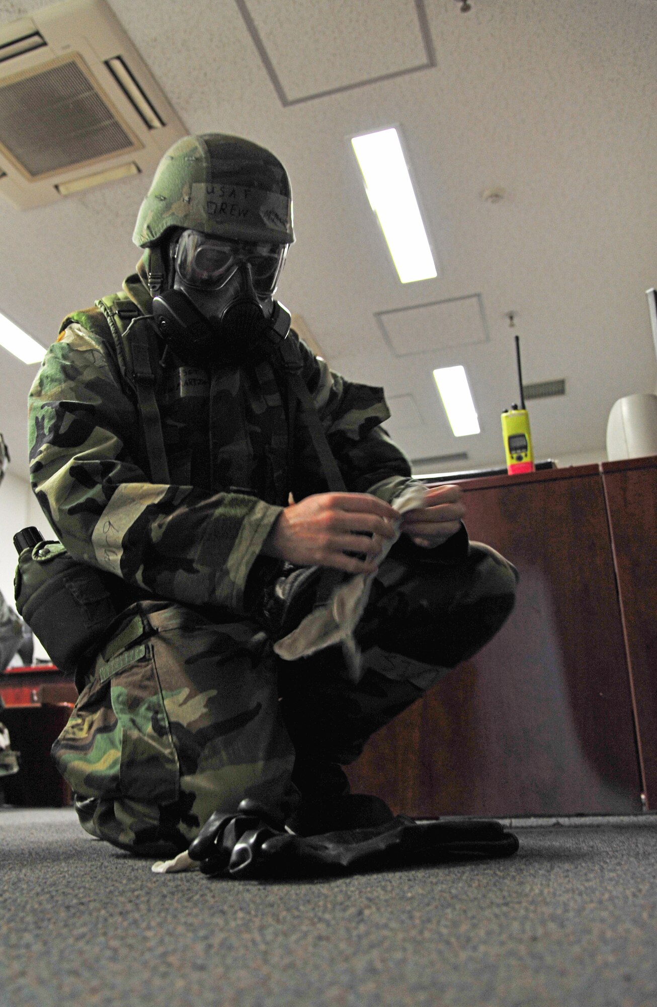U.S. Air Force Staff Sgt. Drew Martin, 35th Communications Squadron base equipment control officer, prepares to insert his glove liners before conducting a post attack reconnaissance sweep at Misawa Air Base, Japan, May 7, 2014. Following a simulated attack, Airmen must conduct PAR sweeps outside their area of responsibility to assess the status of infrastructure and check for unexploded ordnance or provide aid to injured. (U.S. Air Force photo/Senior Airman Jose Hernandez-Domitilo)