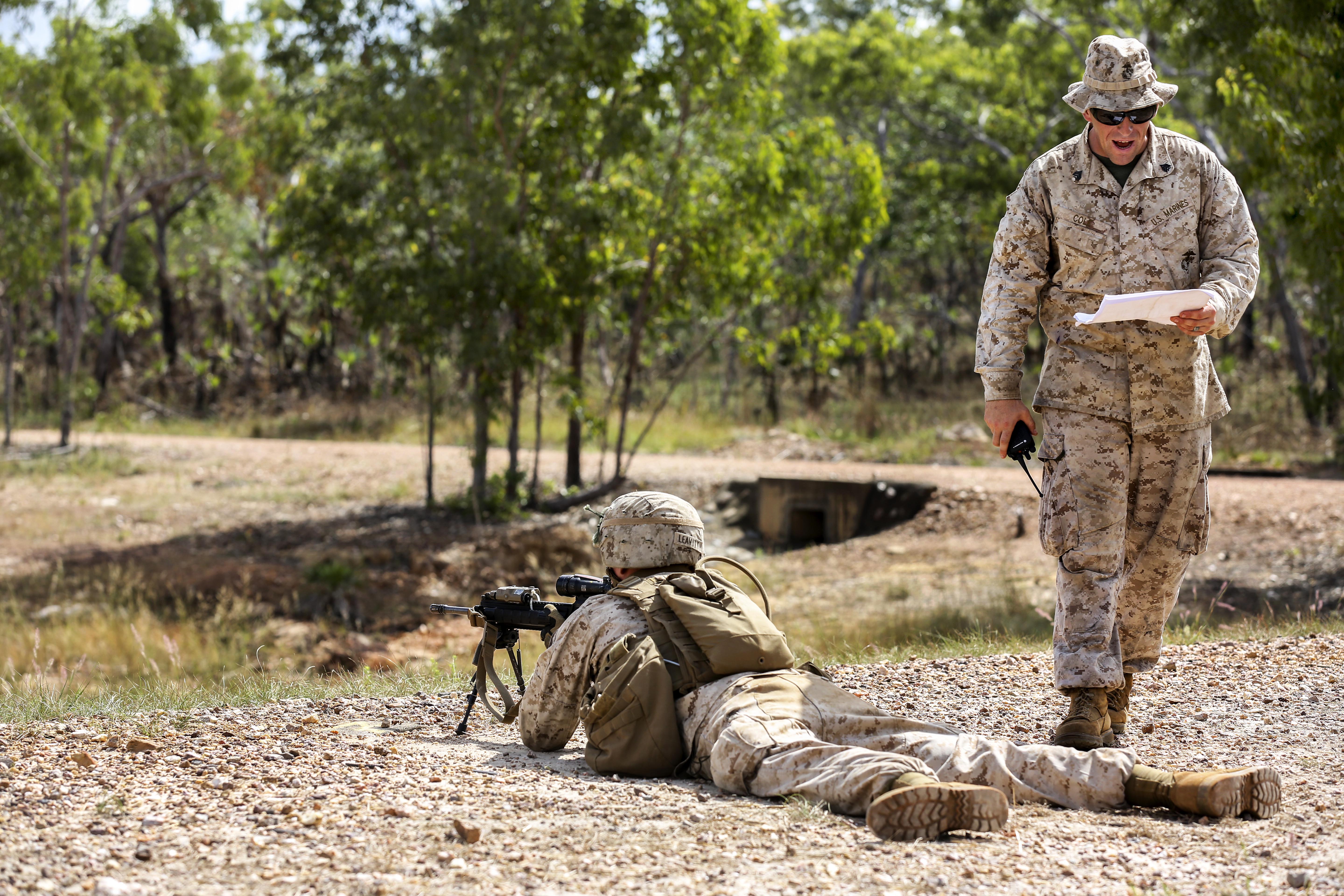 U.S. Marine Corps Sgt. Robert Cole informs Marines of the firing