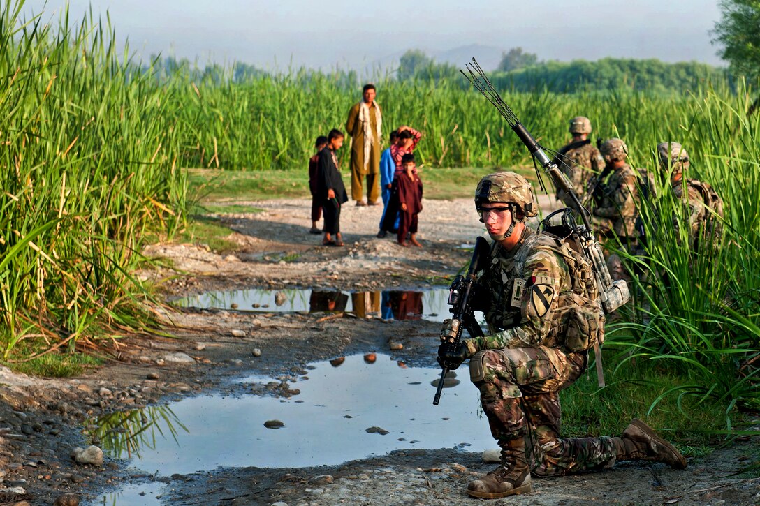 U.S. Army Pfc. Nicholas Peterson, foreground, provides security with his team during a patrol around Forward Operating Base Fenty in Afghanistan's Nangarhar province, Aug. 22, 2013. Peterson is assigned to the 1st Cavalry Division's 4th Squadron, 9th Cavalry Regiment, 2nd Armored Brigade Combat Team. The purpose of the early morning patrol was to check the security of Fenty's perimeter as well as engage the people living in the area.  
