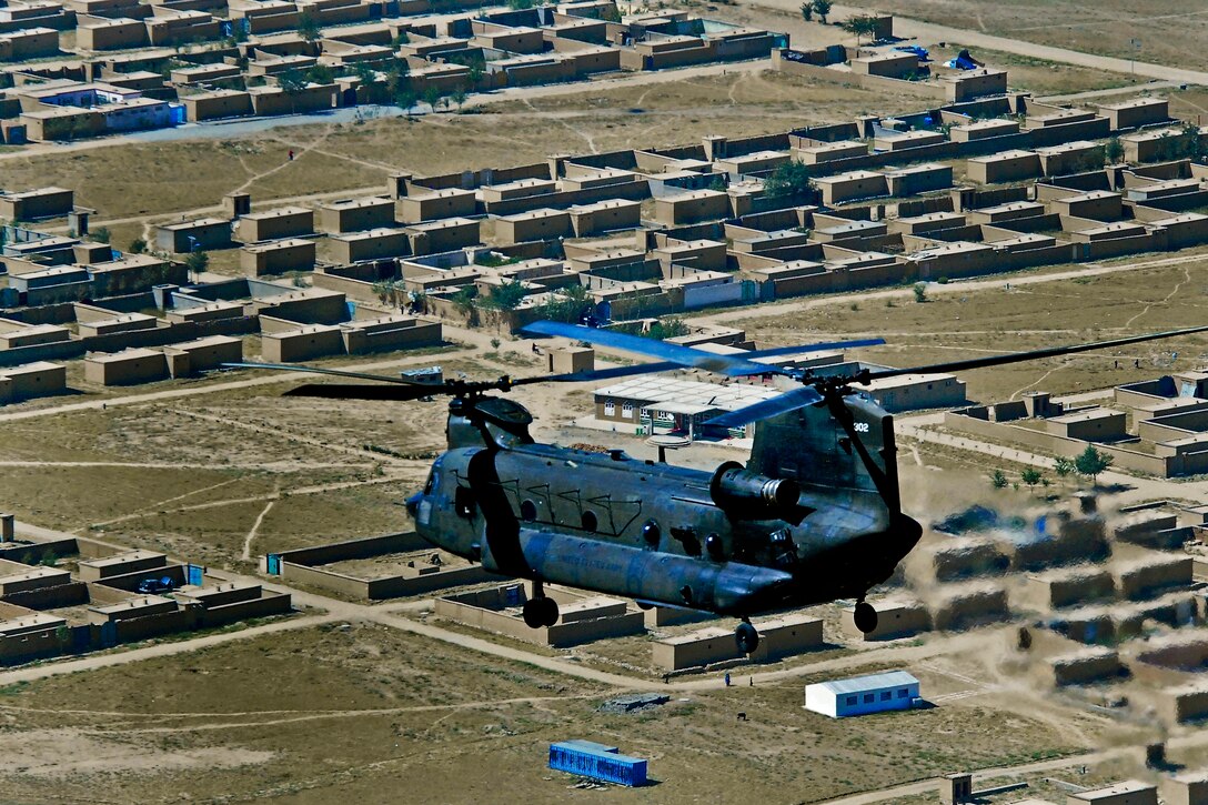A CH-47 Chinook helicopter flies a mission to move equipment over Kabul province, Afghanistan, Aug. 24, 2013. The crew is assigned to 2nd Battalion, 36th Combat Aviation Brigade.  
