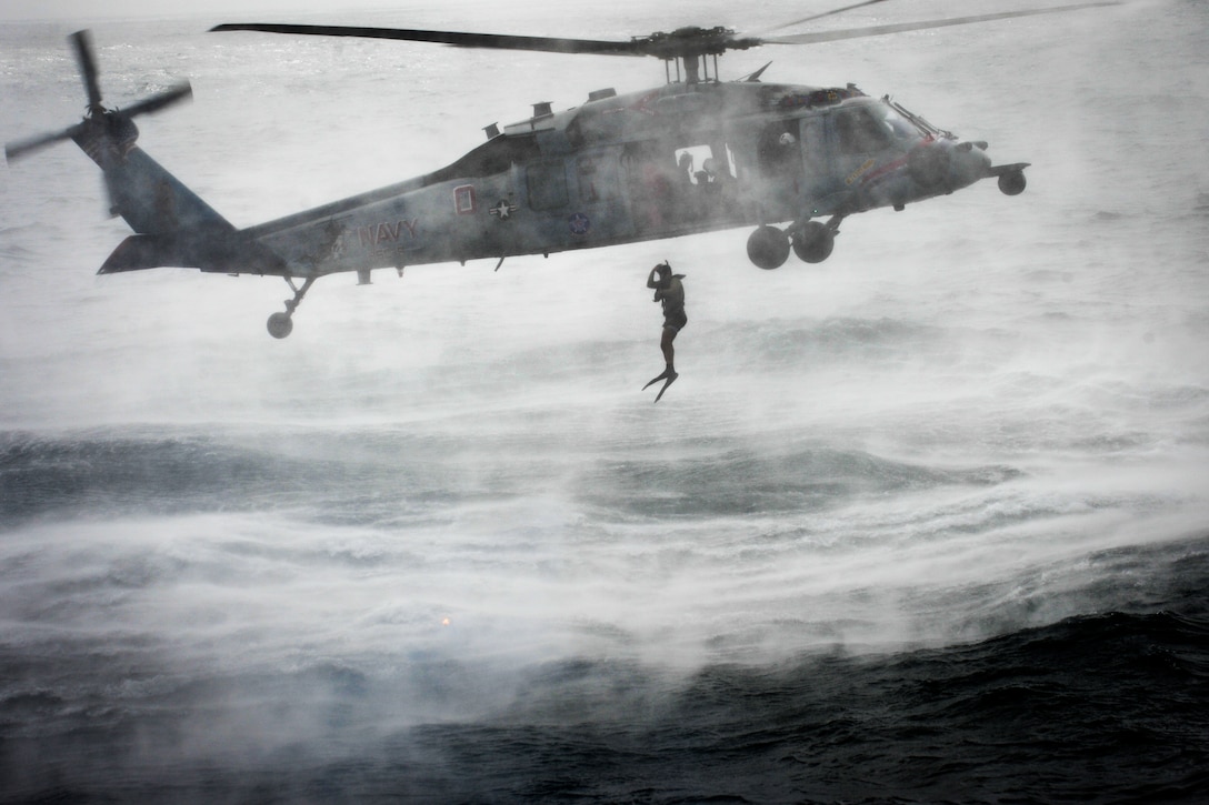 A U.S. Navy search and rescue swimmer jumps from an MH-60S Seahawk helicopter during training in the U.S. 5th Fleet area of responsibility, Aug. 17, 2013. The swimmer is assigned to Helicopter Sea Combat Squadron 6, which is deployed with the Nimitz Carrier Strike Group to conduct security operations and security cooperation efforts to support Operation Enduring Freedom.  
