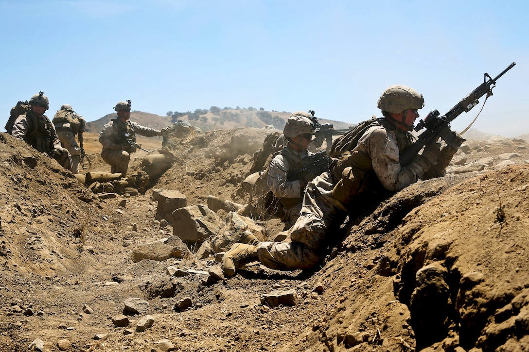 Marines engage targets from a cleared trench during live-fire training on Marine Corps Base Camp Pendleton, Calif., Aug. 12, 2013. The Marines are assigned to Echo Company, 2nd Battalion, 5th Marine Regiment.  
