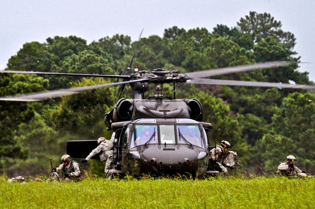 Soldiers exit from a UH-60 Black Hawk helicopter during an air insertion exercise on Fort Pickett, Va., Aug. 17, 2013. The soldiers are assigned to the New Jersey Army National Guard's 250th Brigade Support Battalion, 50th Infantry Brigade Combat Team.  
